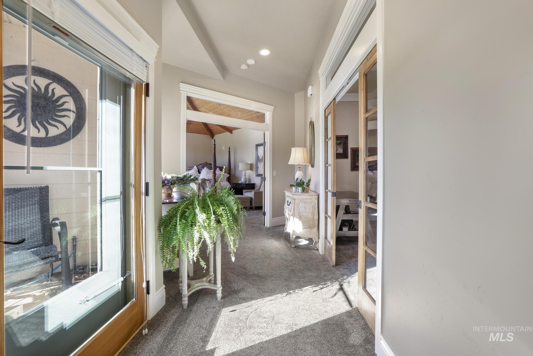 Hallway featuring carpet flooring, beam ceiling, and recessed lighting