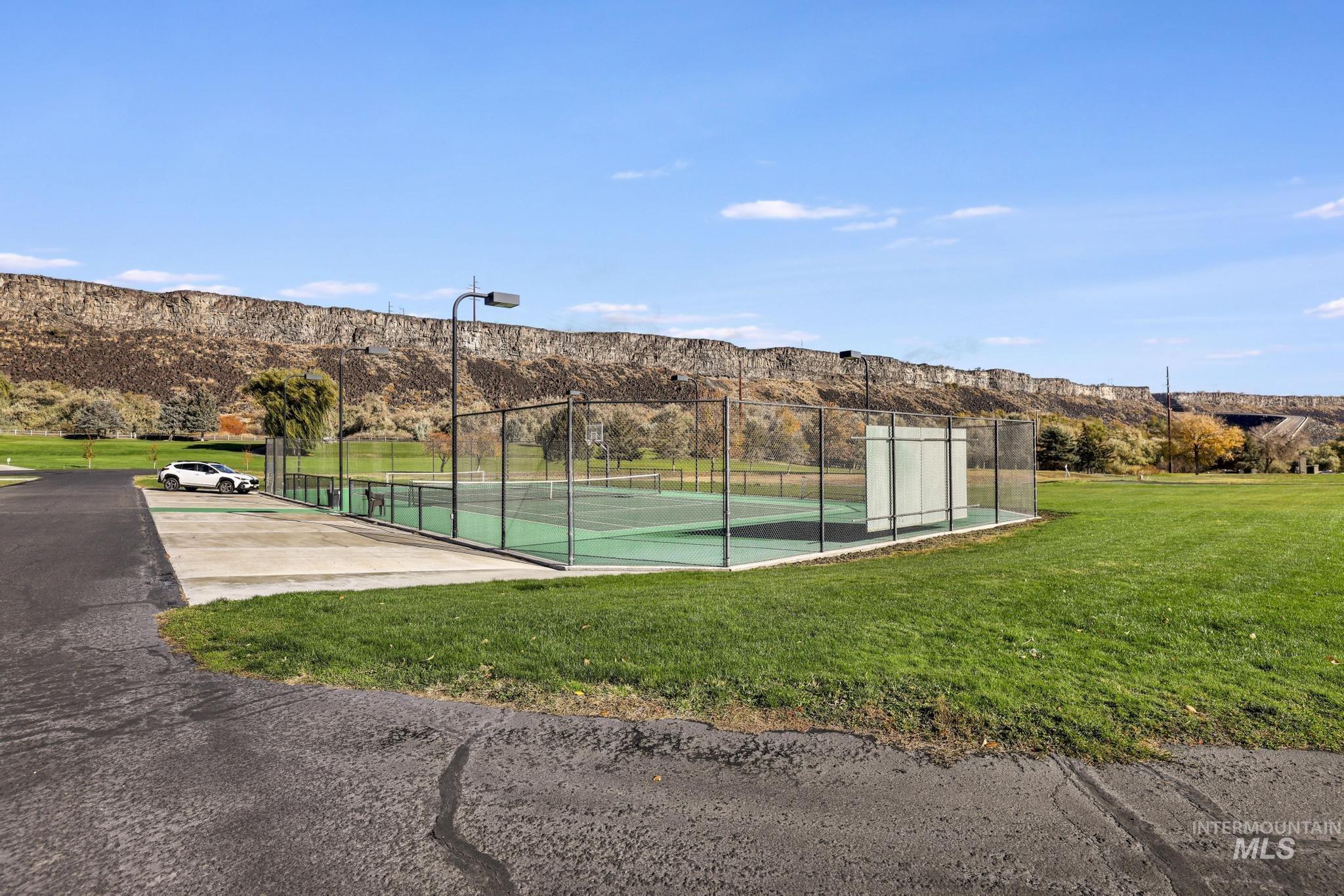 View of tennis court featuring a mountain view