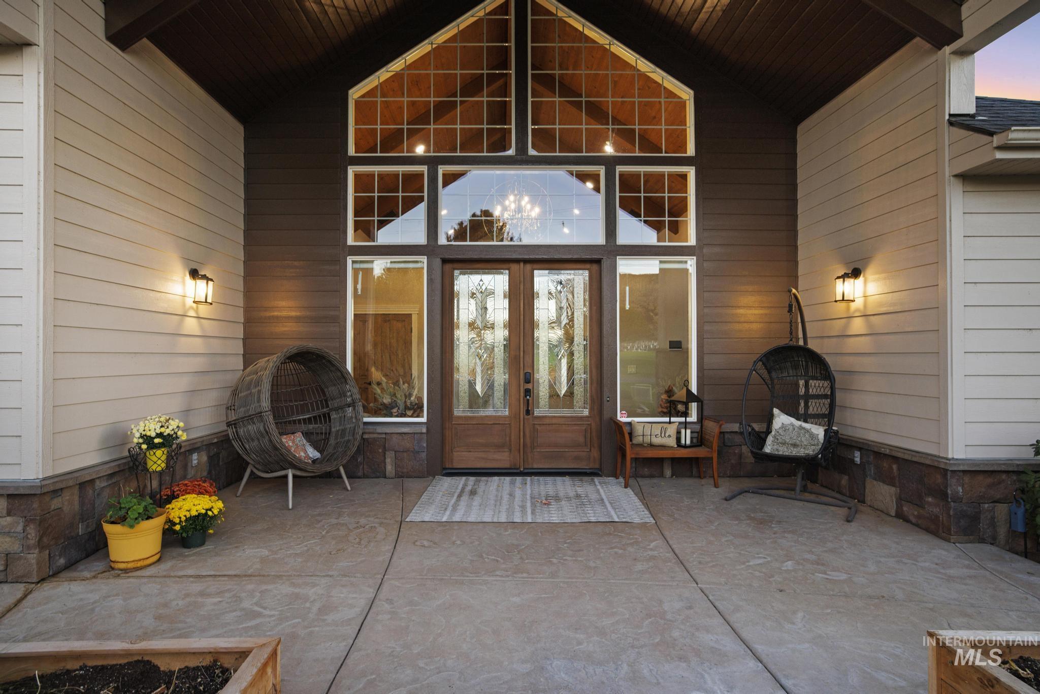 Exterior entry at dusk with a patio and french doors