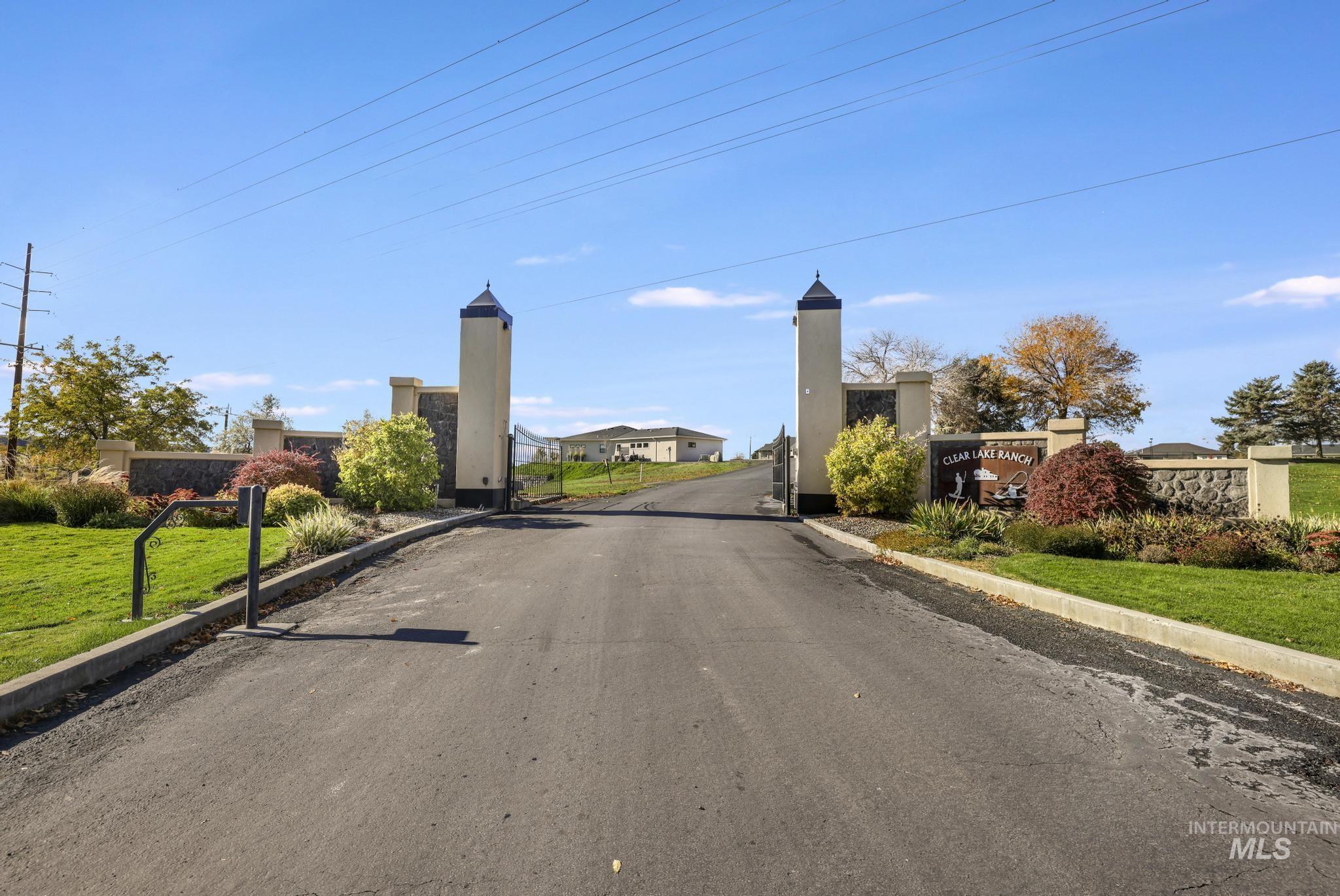 View of street featuring curbs and a gated entry