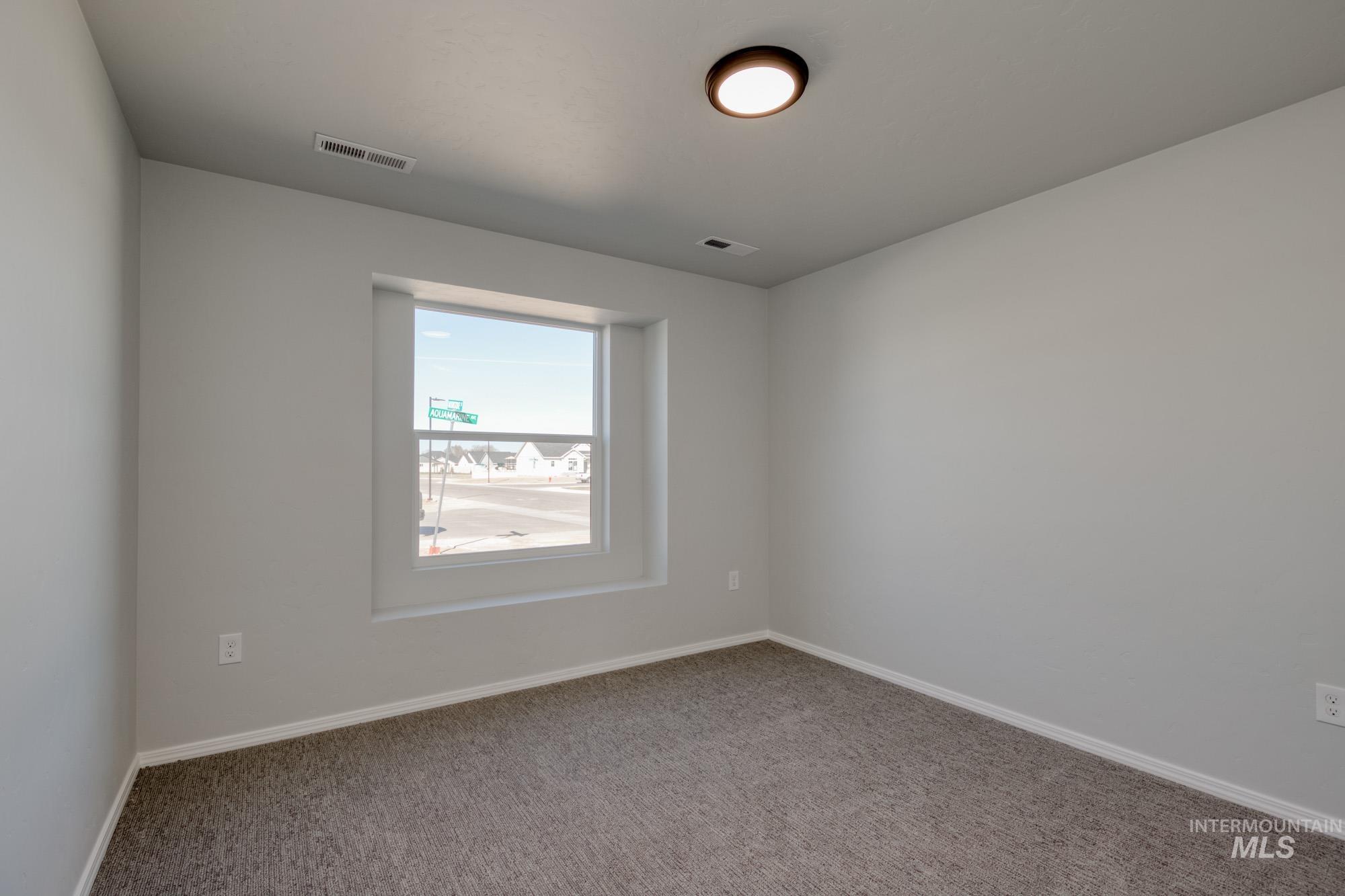 Spare room with carpet floors and baseboards
