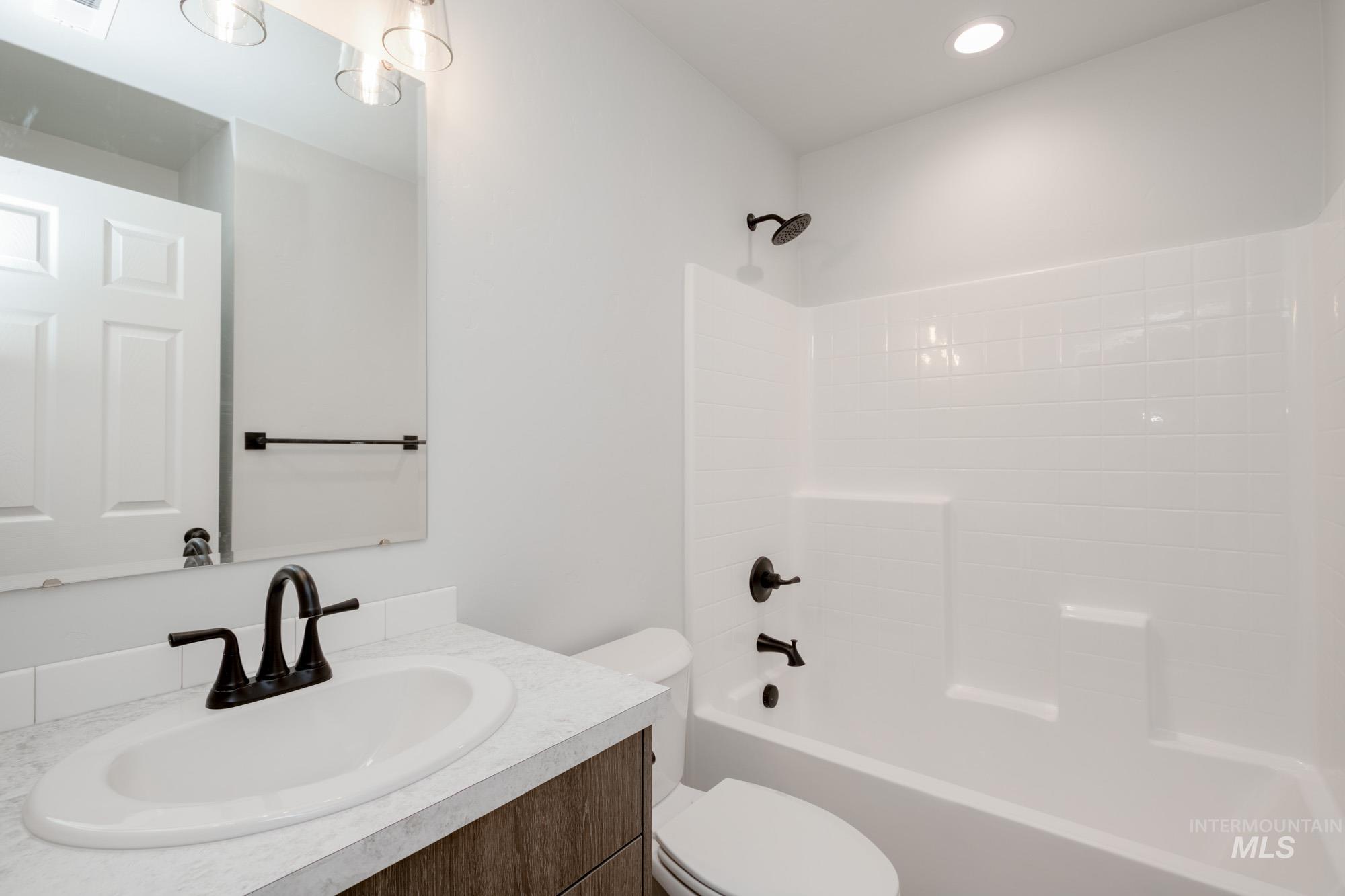 Bathroom featuring vanity and bathing tub / shower combination