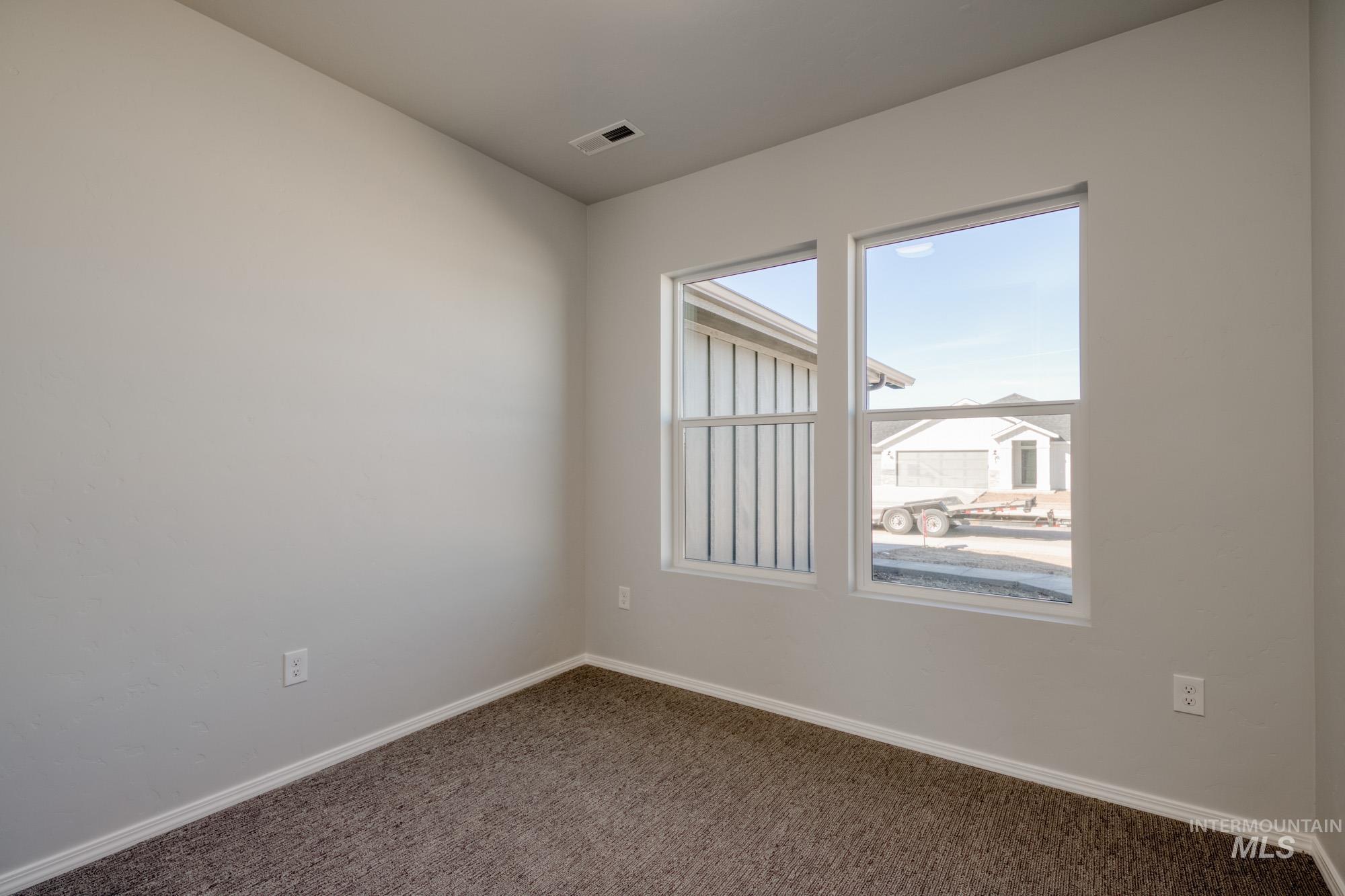 Unfurnished room featuring baseboards and carpet flooring