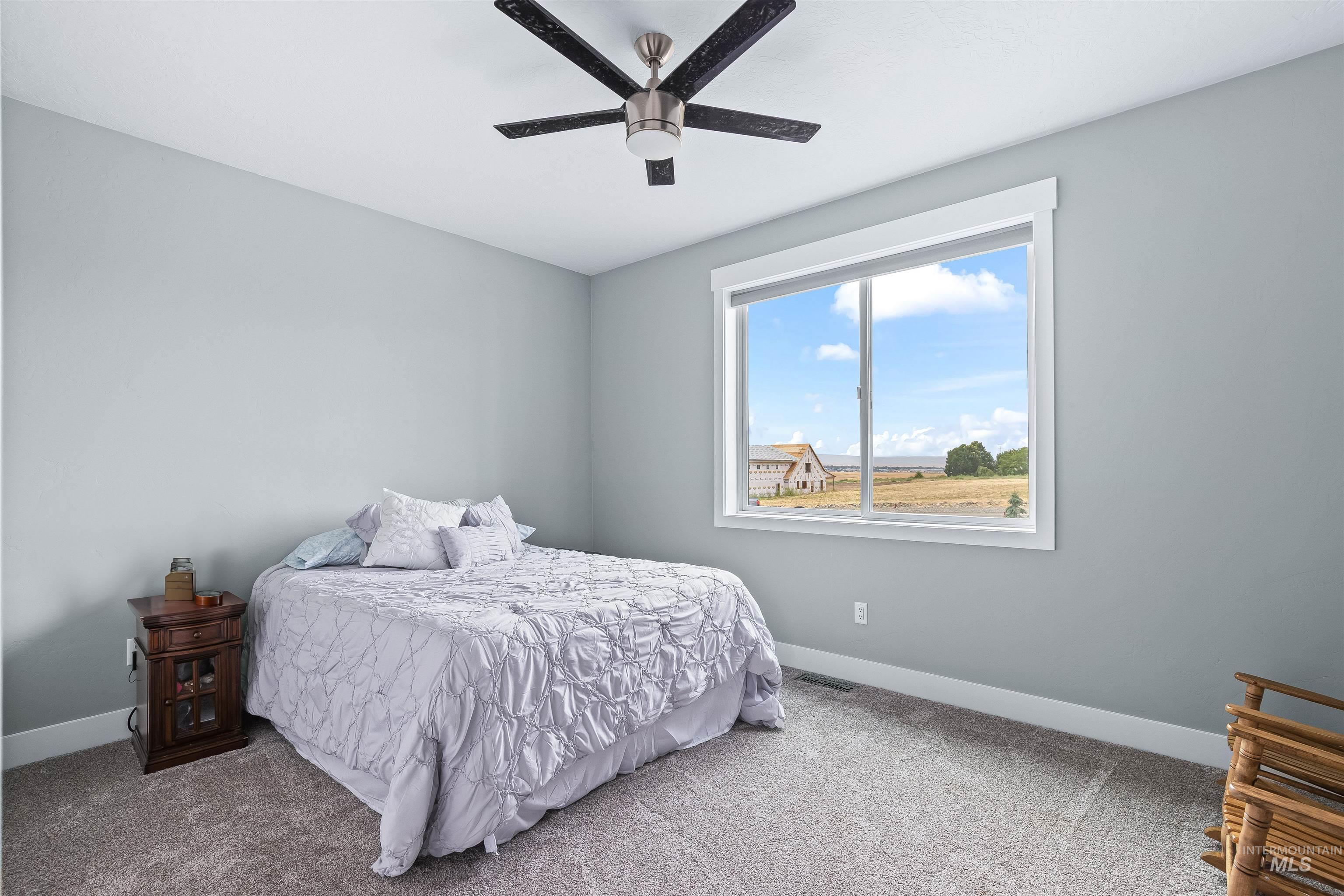 Bedroom with carpet and ceiling fan