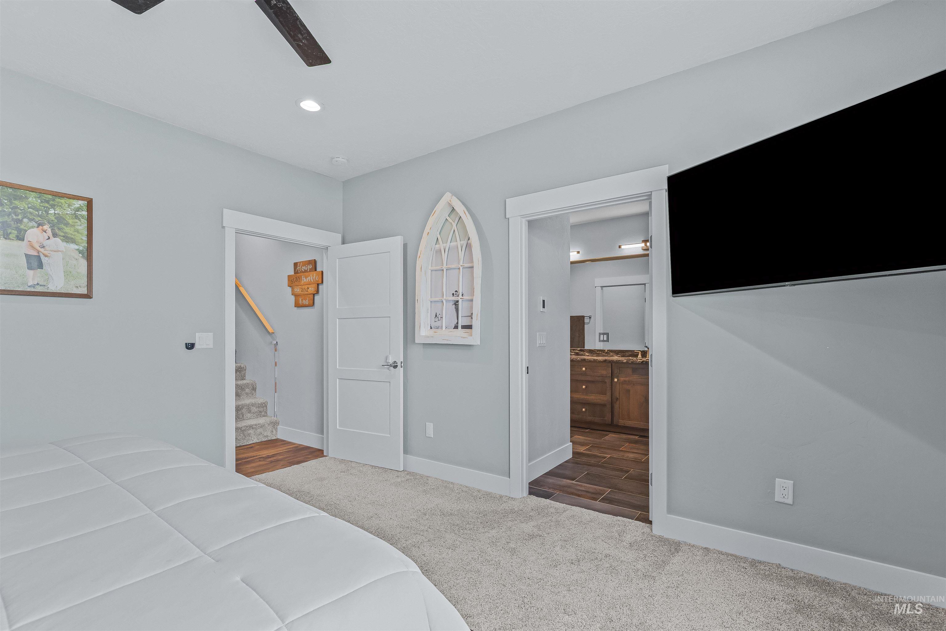 Bedroom featuring carpet flooring, connected bathroom, recessed lighting, and ceiling fan