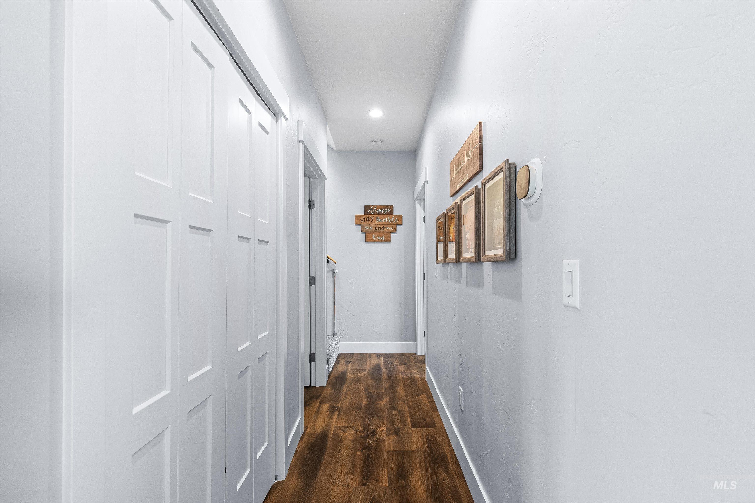 Hallway featuring wood finished floors and recessed lighting