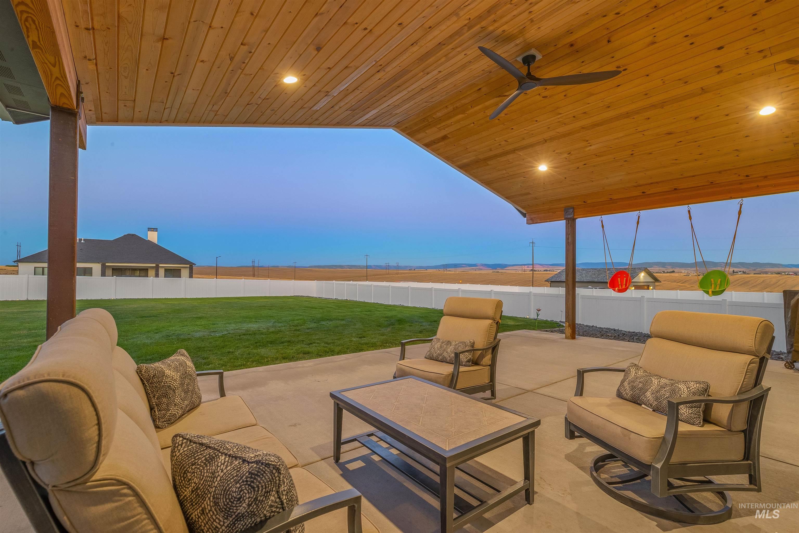 Fenced backyard with an outdoor hangout area and a patio area