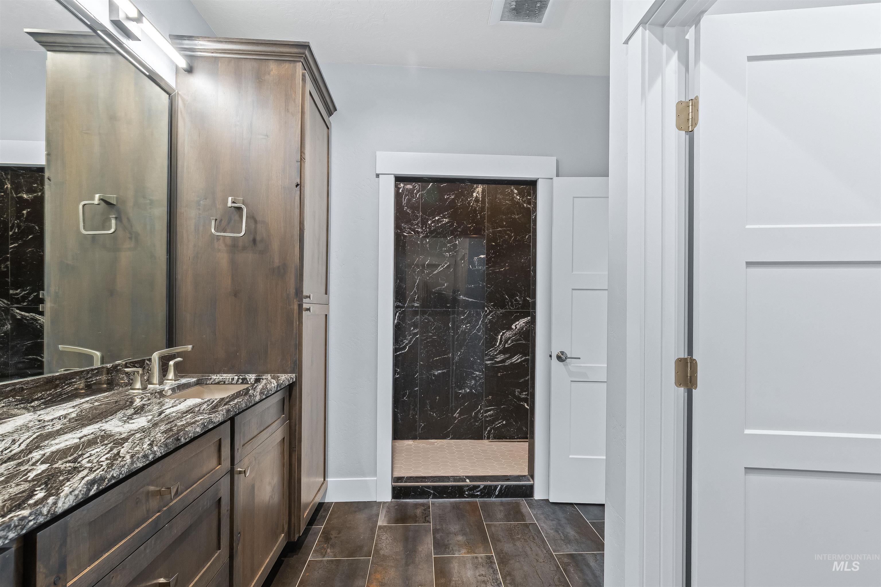 Bathroom with wood tiled floors and vanity