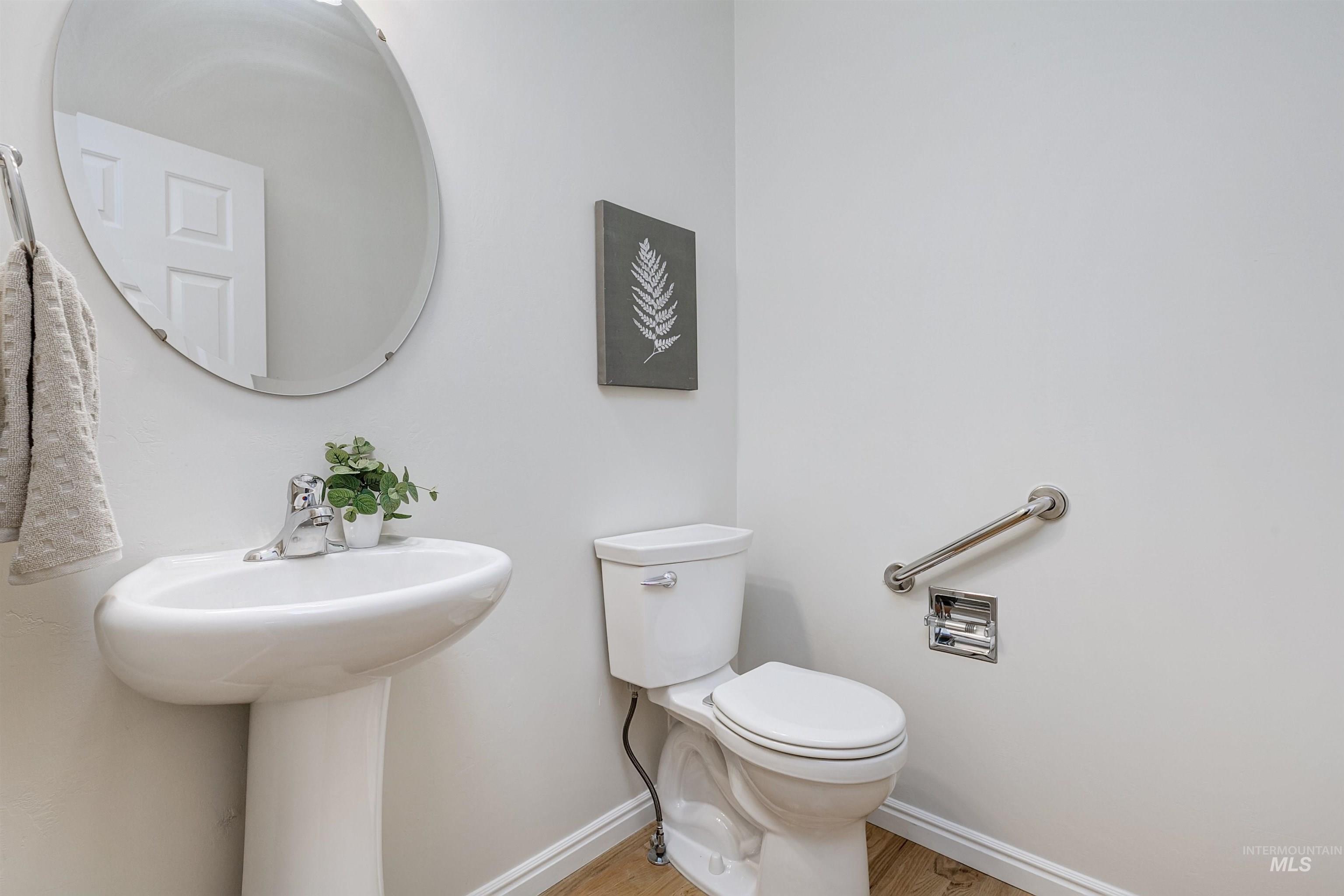 Bathroom featuring baseboards and light wood-style flooring