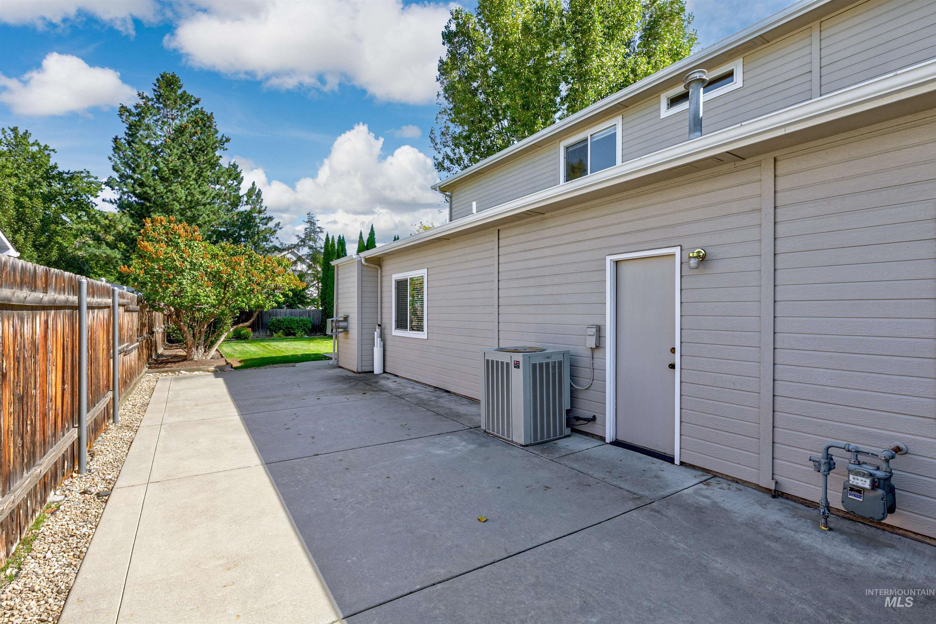 View of side of home featuring a fenced backyard and a patio area