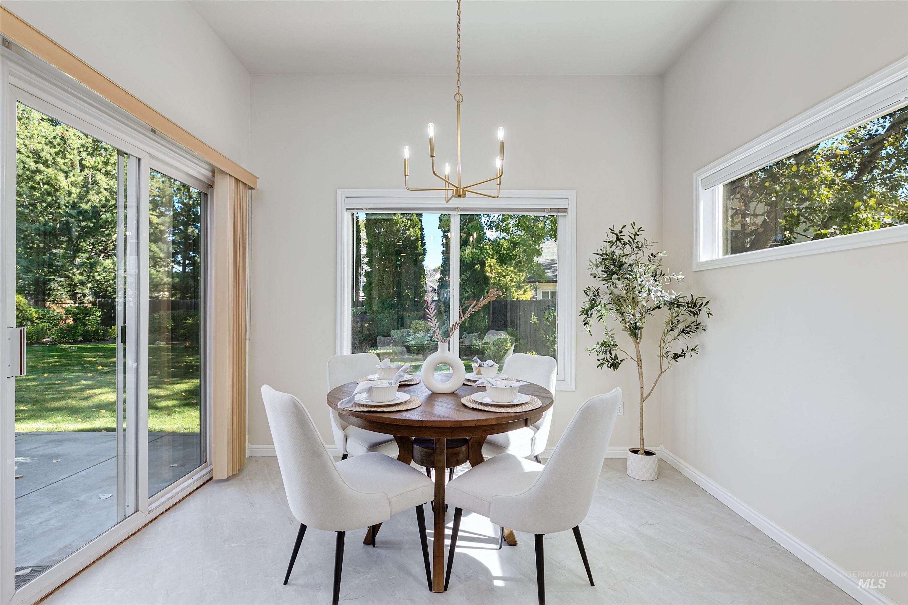 Dining space featuring plenty of natural light and a chandelier