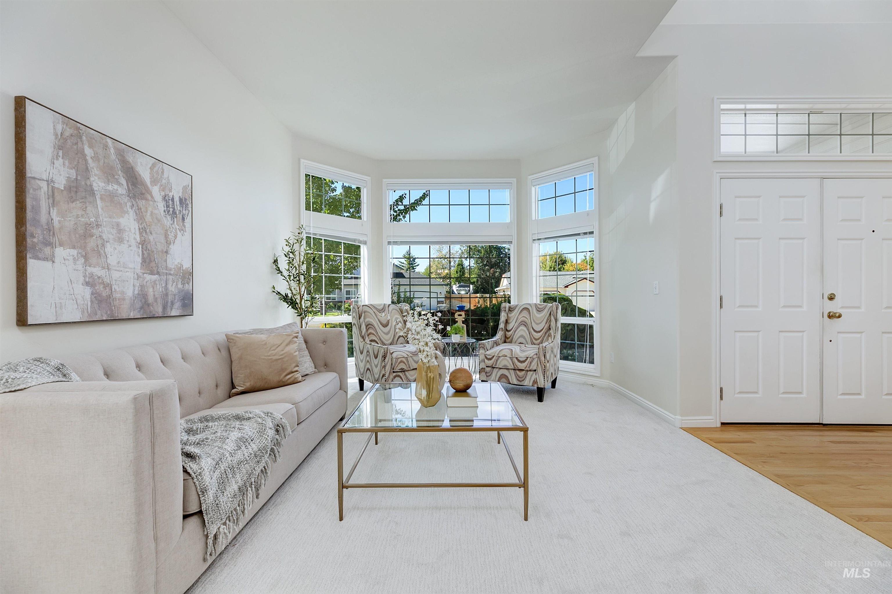 Living area with wood finished floors and a high ceiling