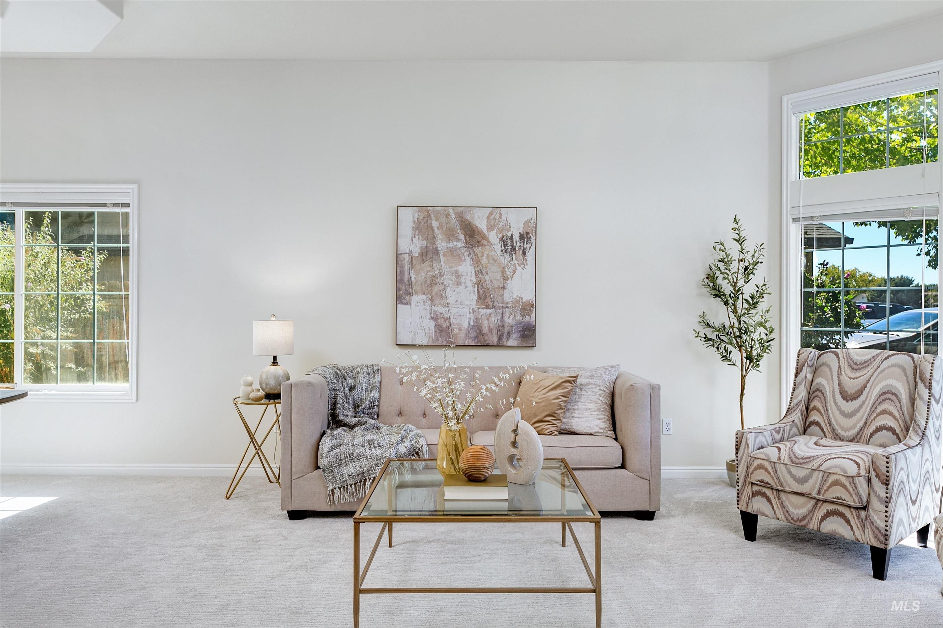 Living room featuring healthy amount of natural light and carpet
