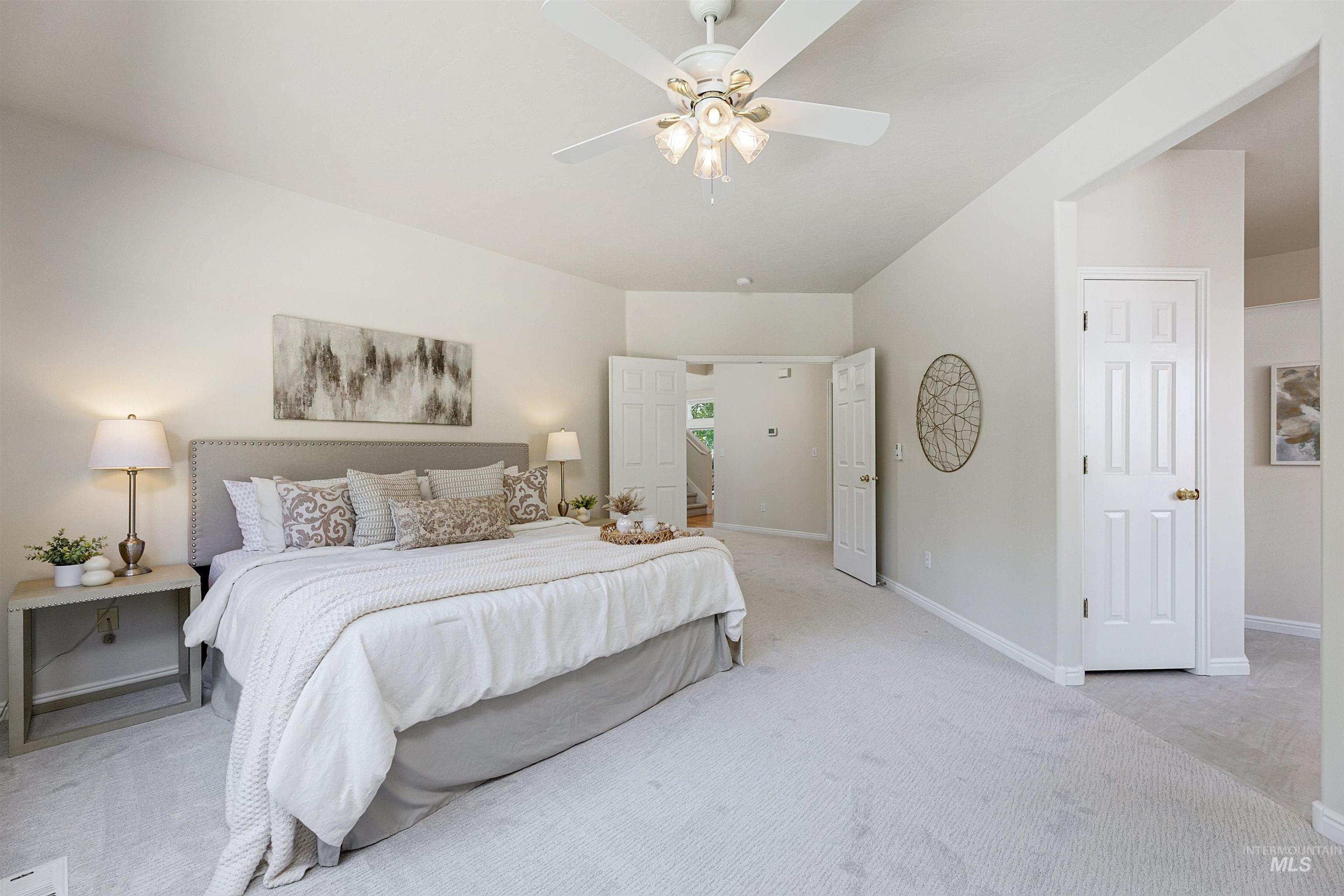 Carpeted bedroom featuring baseboards and ceiling fan