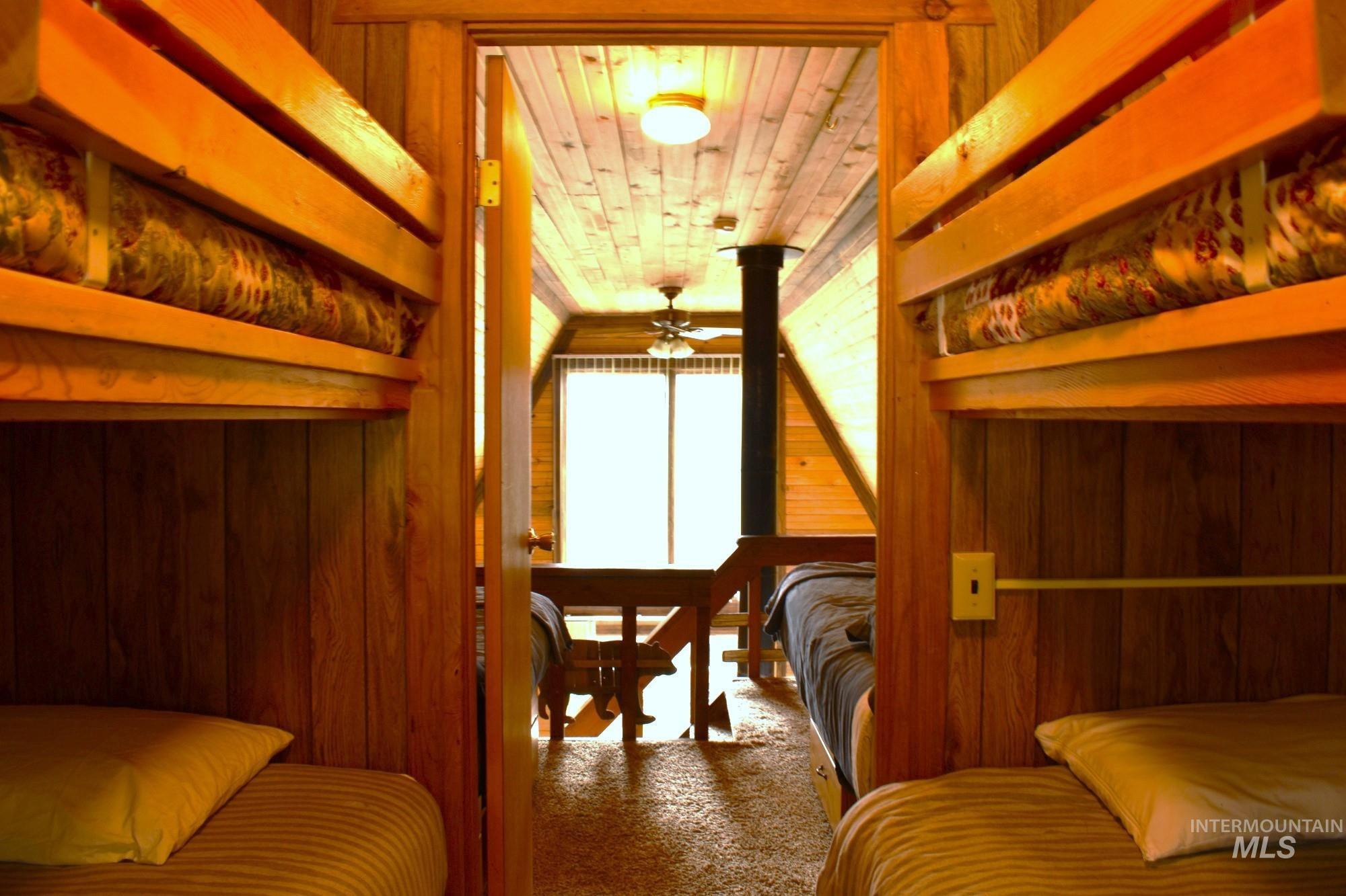 Wood-paneled room featuring built-in bunk beds with solid wood frames