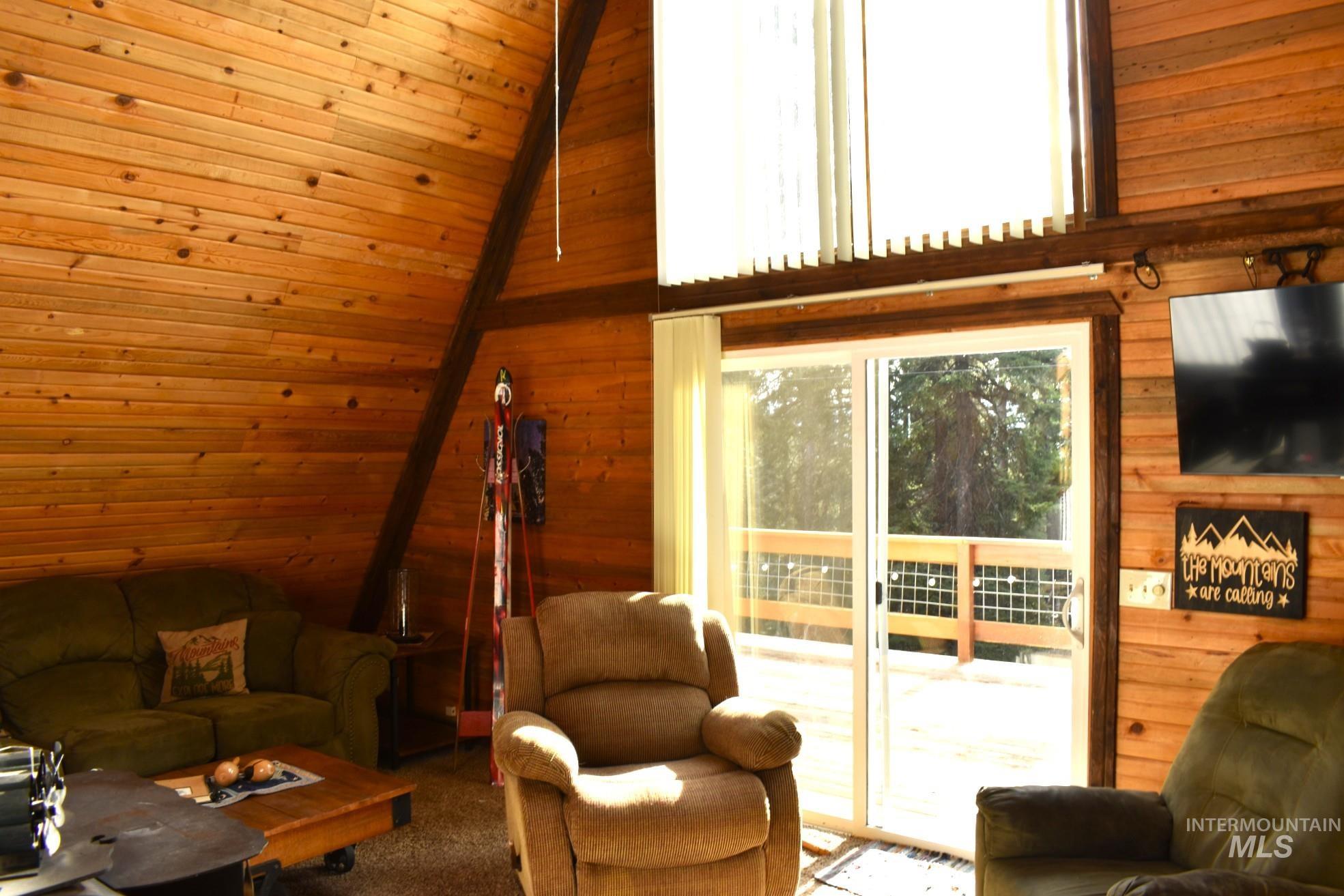 A-frame interior with extensive wood-finish wall and ceiling paneling