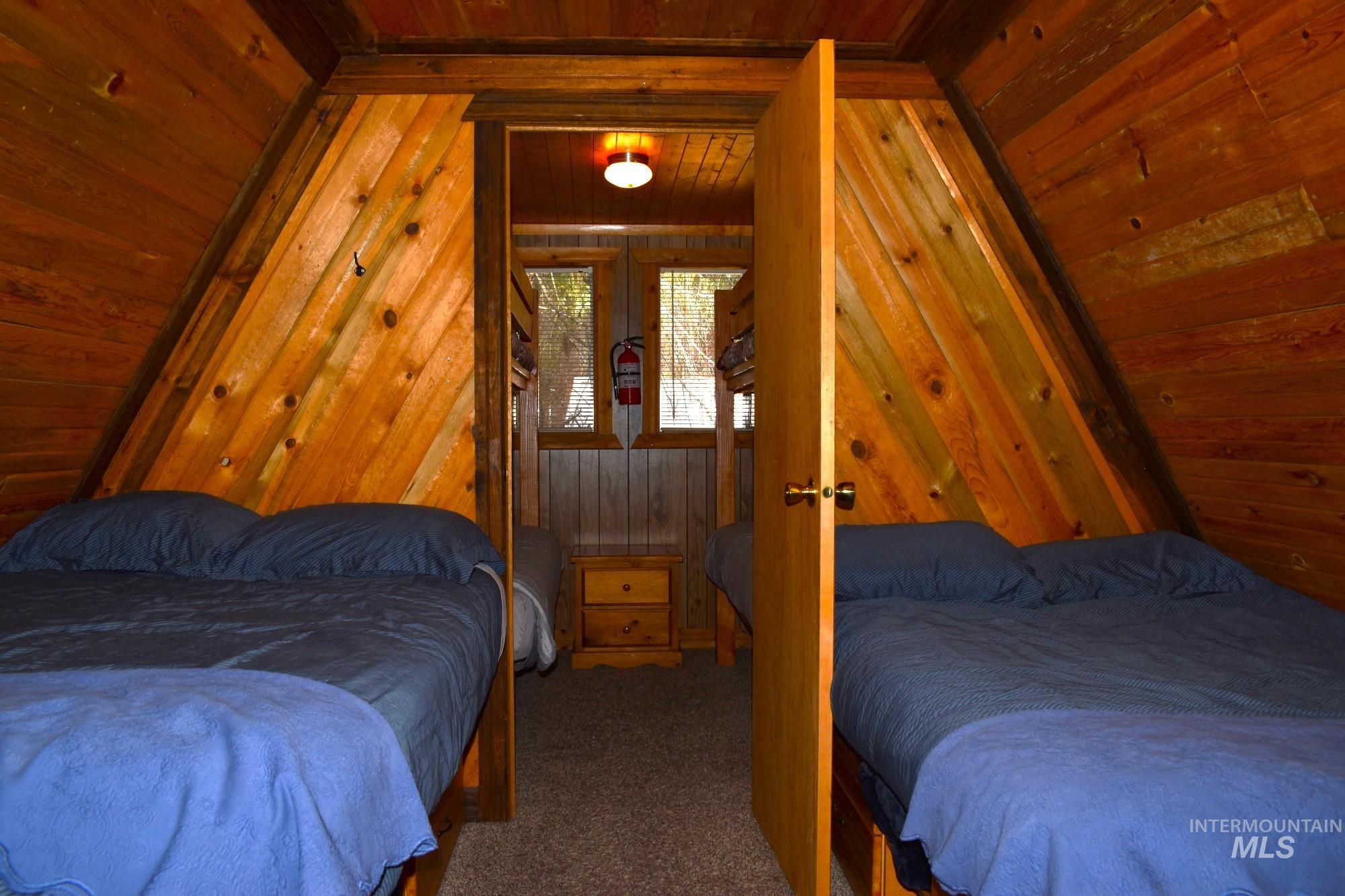 Wood-paneled interior featuring angled walls and a central doorway