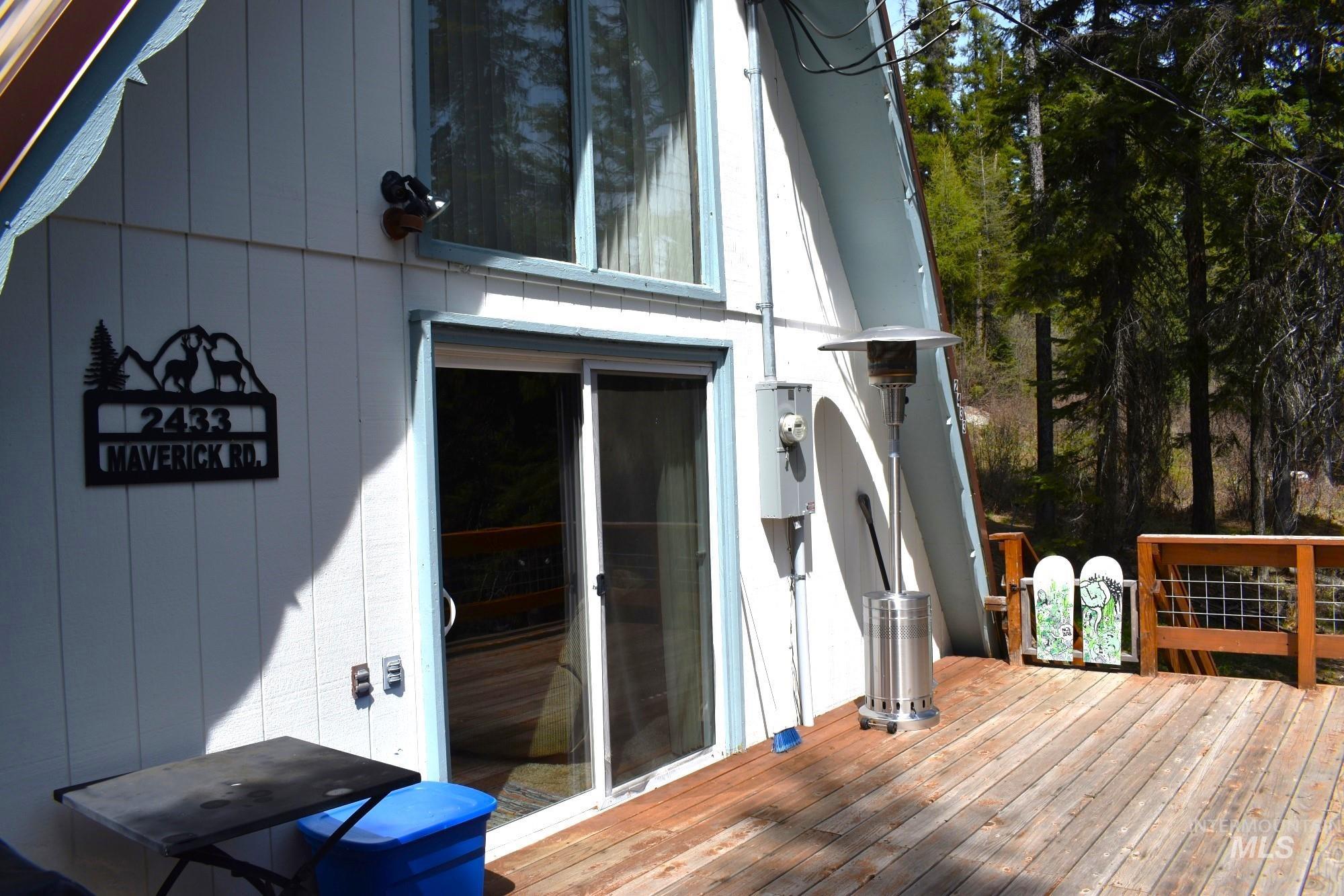 Wood-plank outdoor deck with natural wood railing and metal mesh accents
