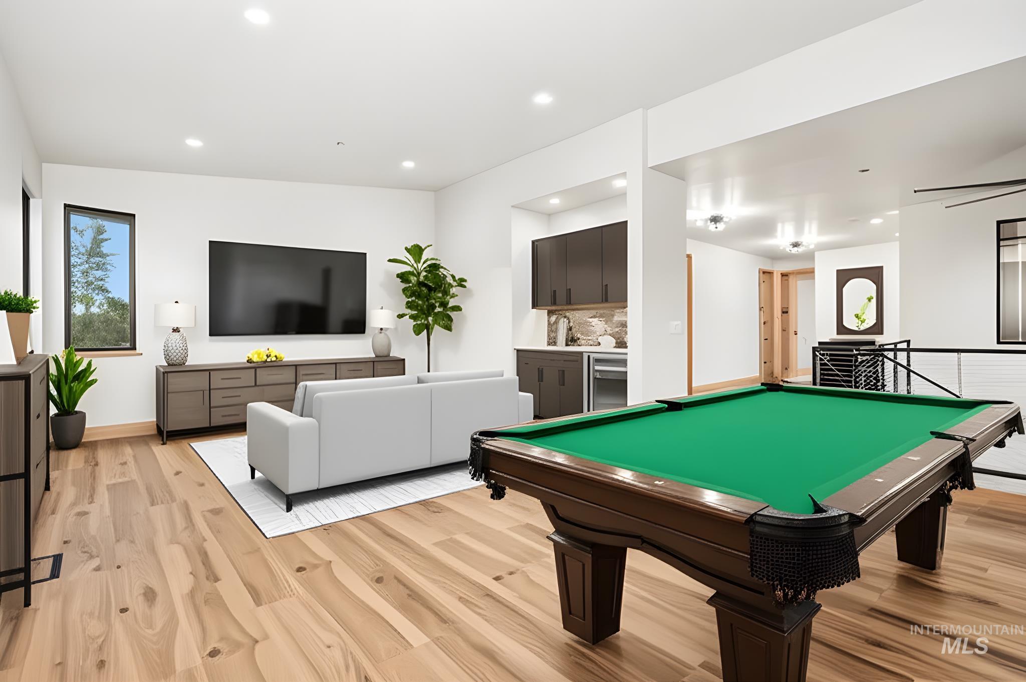 Recreation room featuring recessed lighting, billiards table, light wood finished floors, and bar area