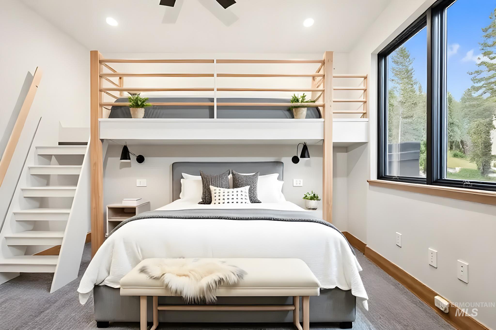 Carpeted bedroom with a ceiling fan and recessed lighting