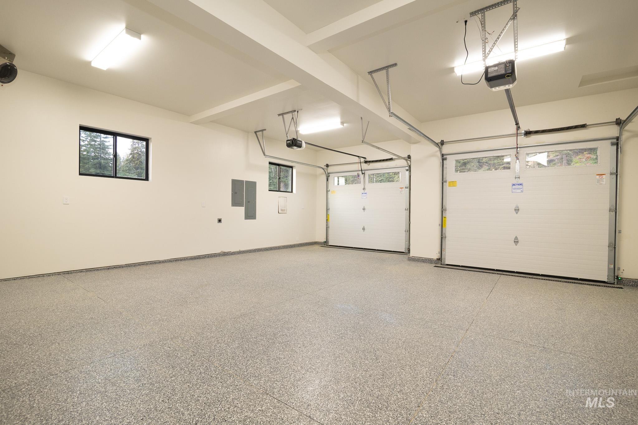 Garage with electric panel and a garage door opener