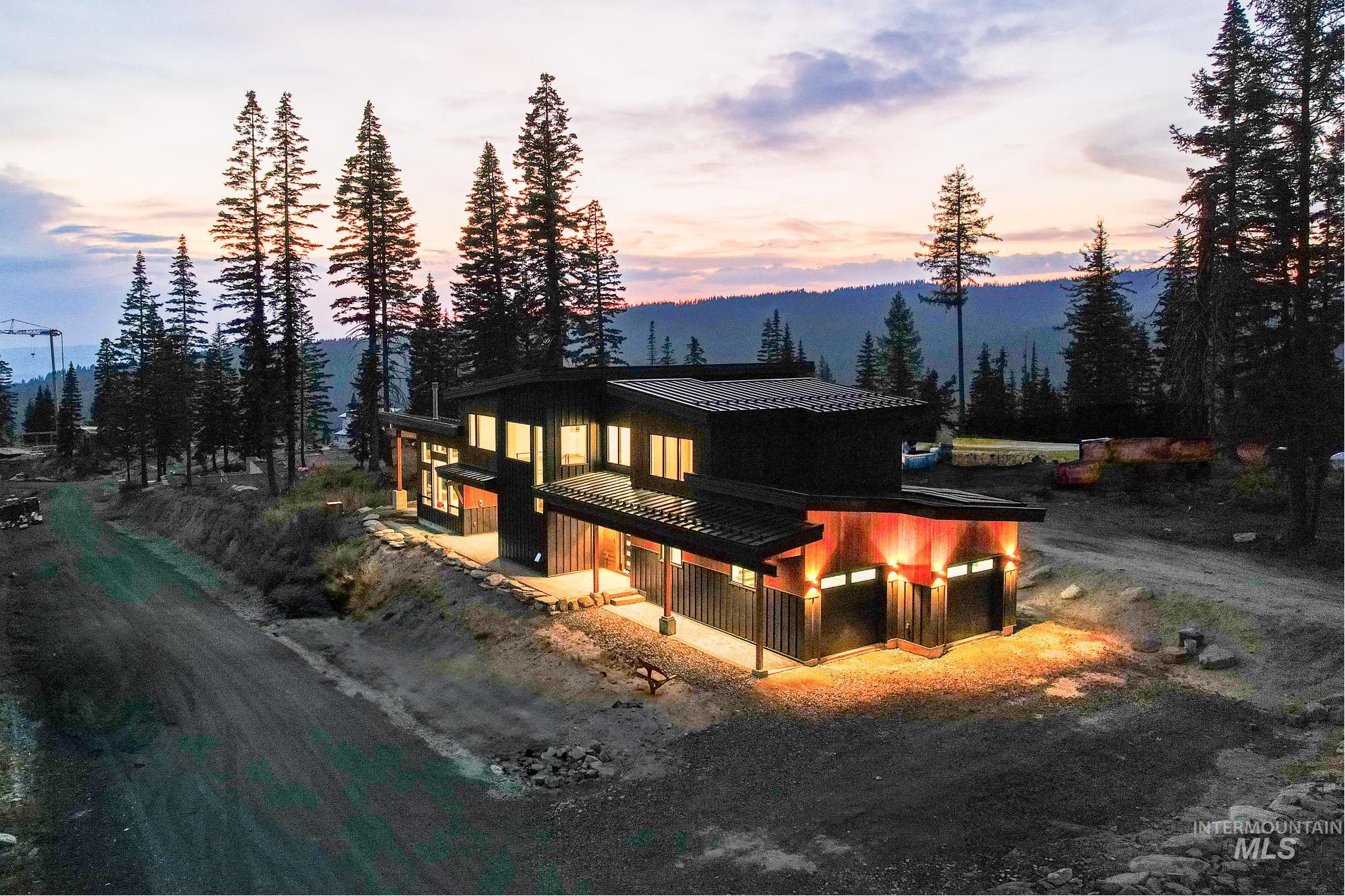 Rear view of house featuring a standing seam roof and a metal roof