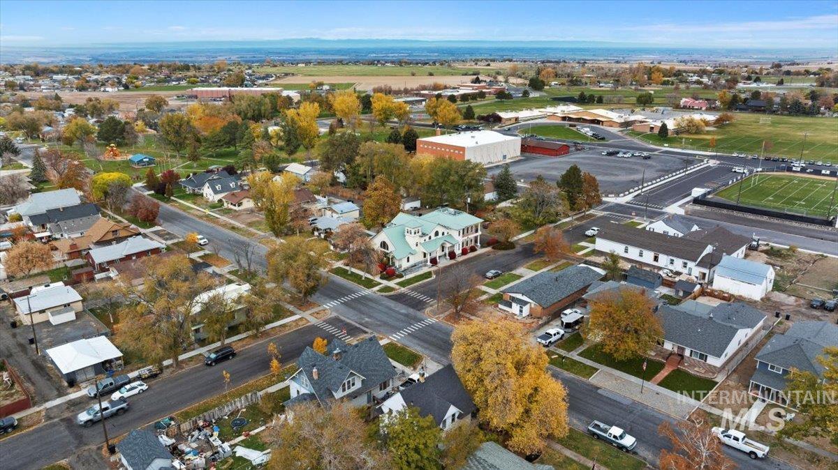 Aerial view of property and surrounding area with nearby suburban area
