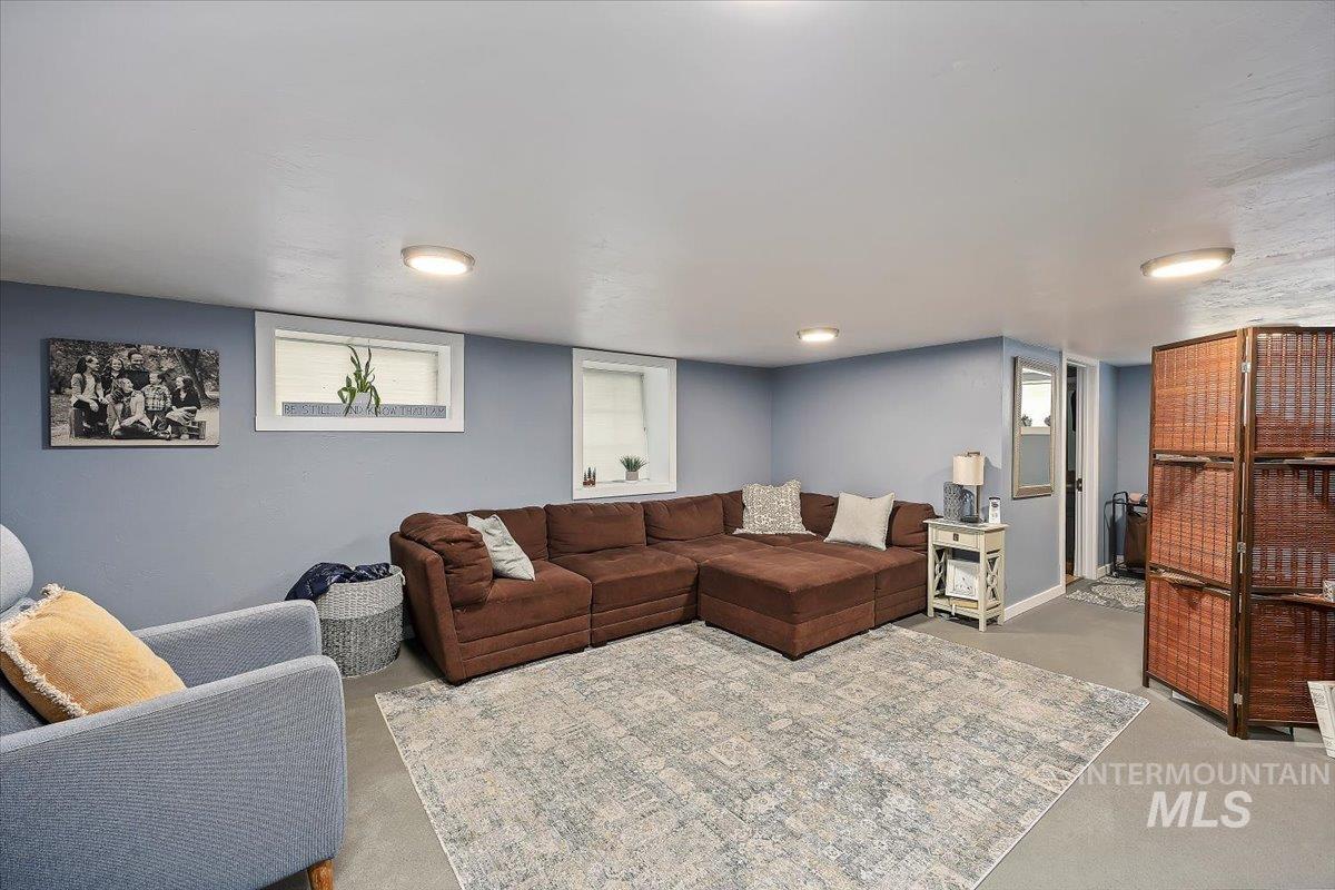 Living area featuring finished concrete floors and baseboards
