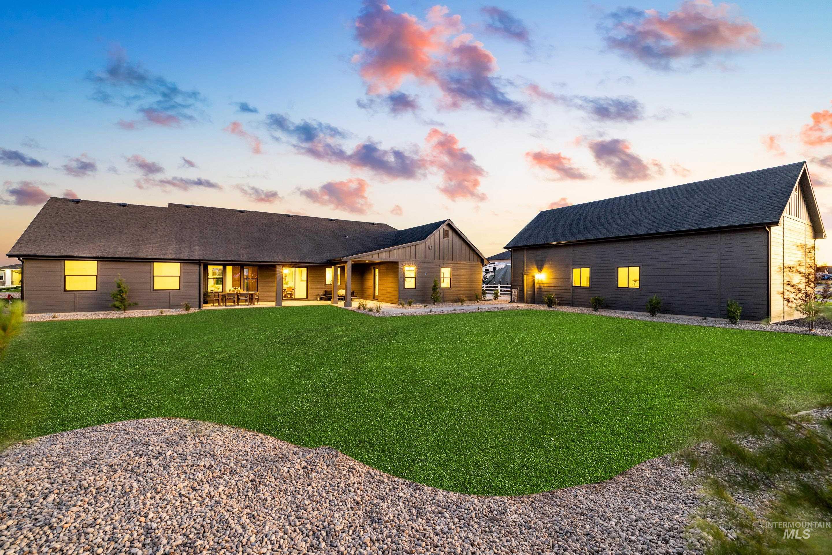 View of front of home featuring a shingled roof and a front lawn