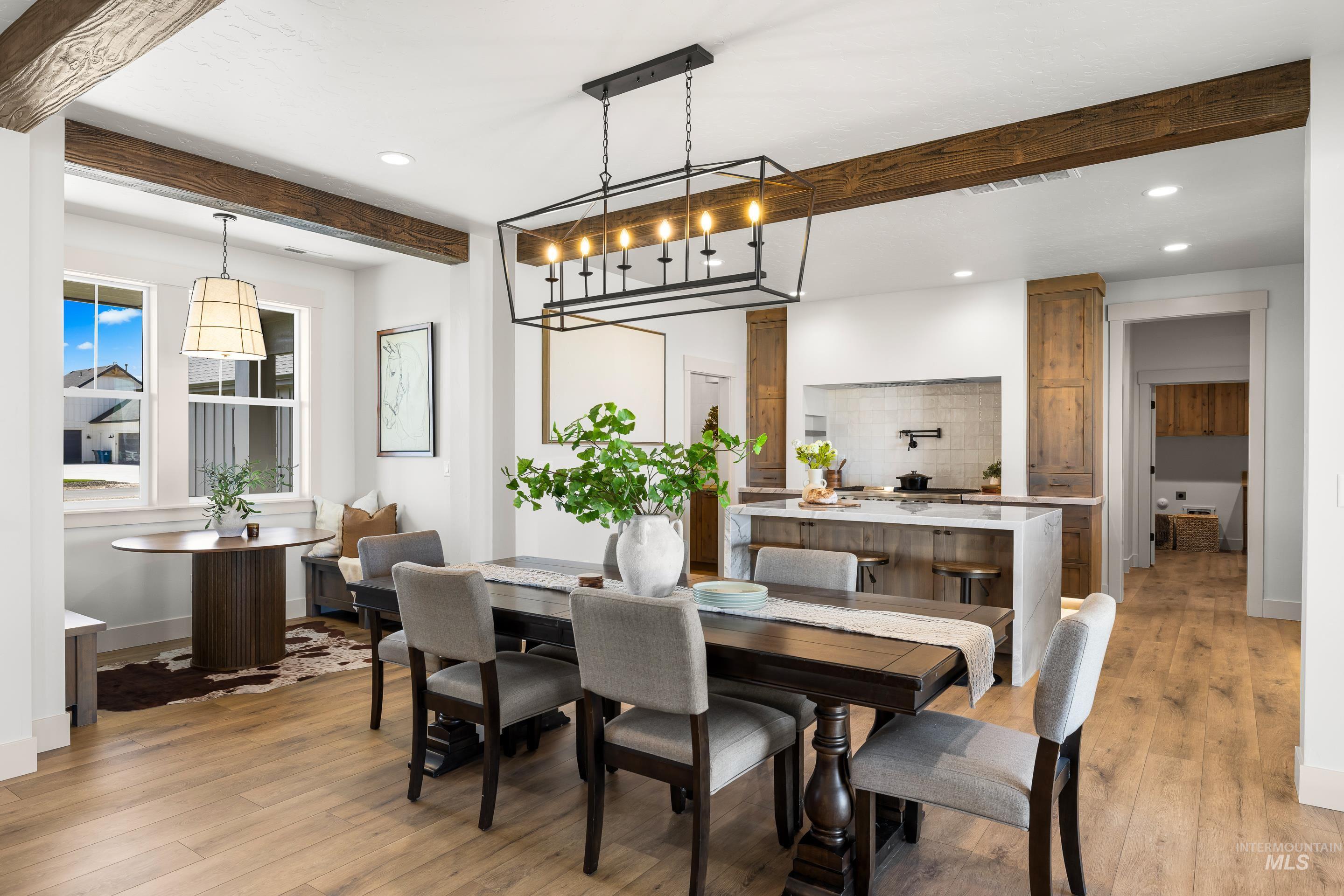 Dining space featuring beamed ceiling, recessed lighting, and light wood-style flooring