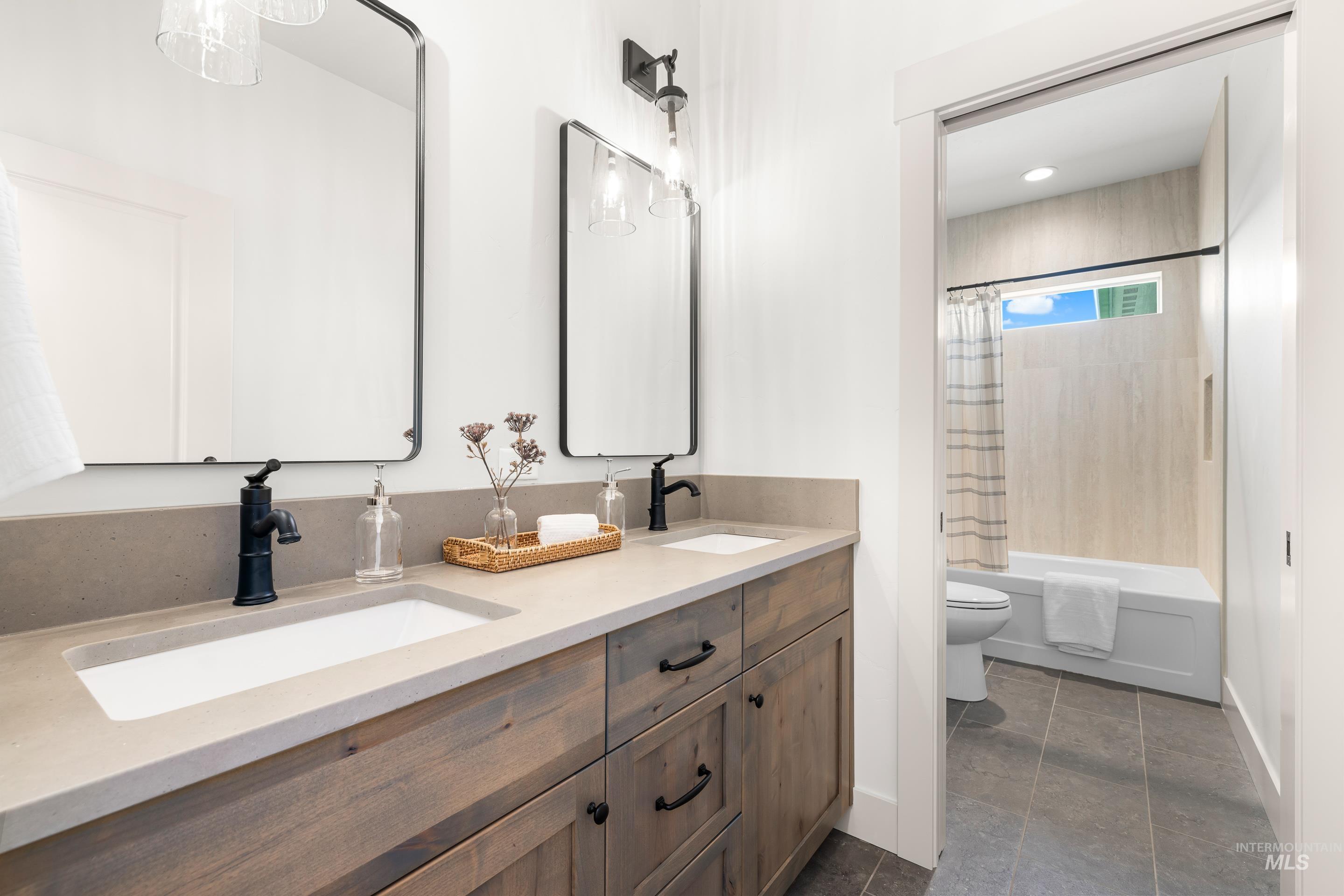 Bathroom with double vanity, shower / bathtub combination with curtain, tile patterned flooring, and recessed lighting