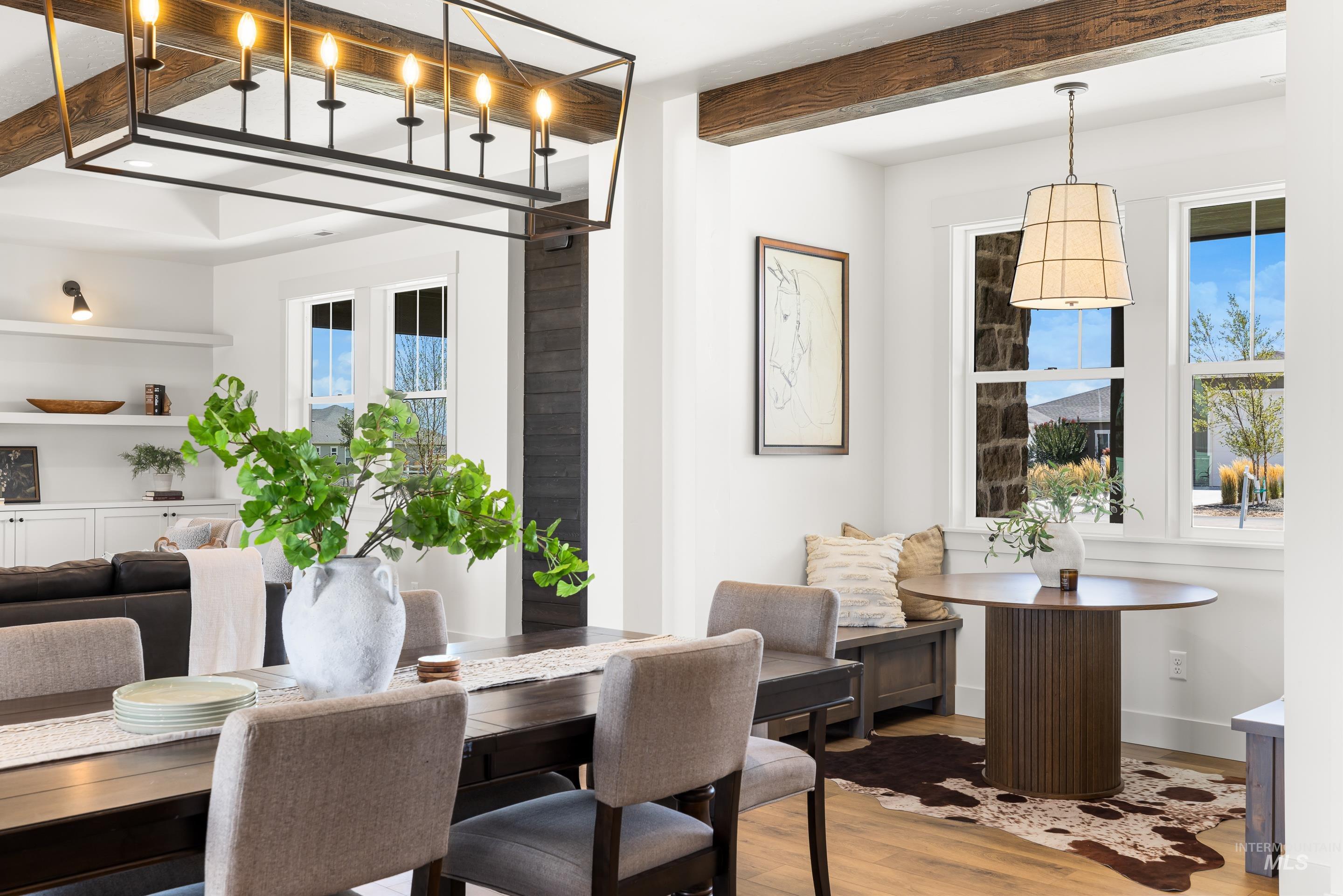 Dining room featuring wood finished floors, beamed ceiling, and plenty of natural light