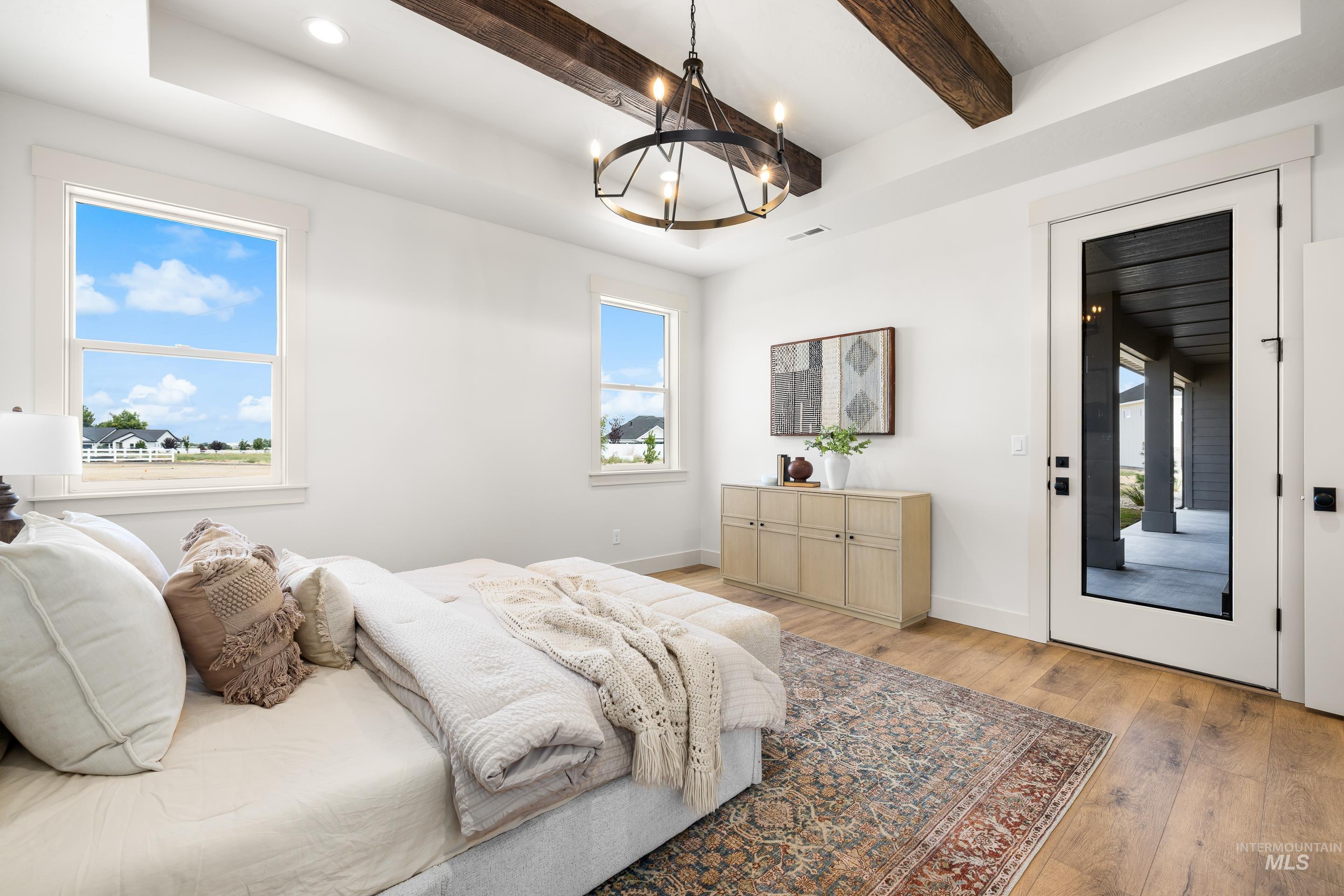 Bedroom with light wood-type flooring, a chandelier, beam ceiling, access to outside, and recessed lighting