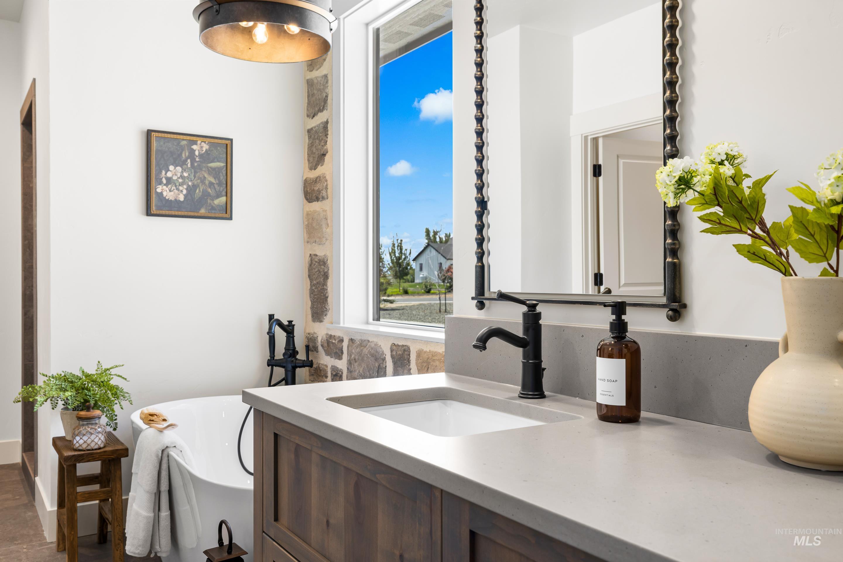 Bathroom featuring a freestanding bath and vanity