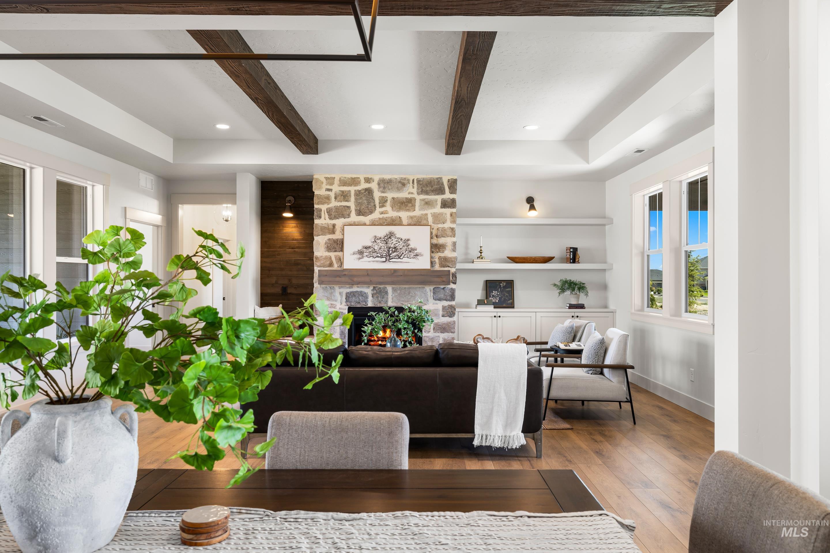 Living area with a fireplace, hardwood / wood-style floors, beam ceiling, and recessed lighting