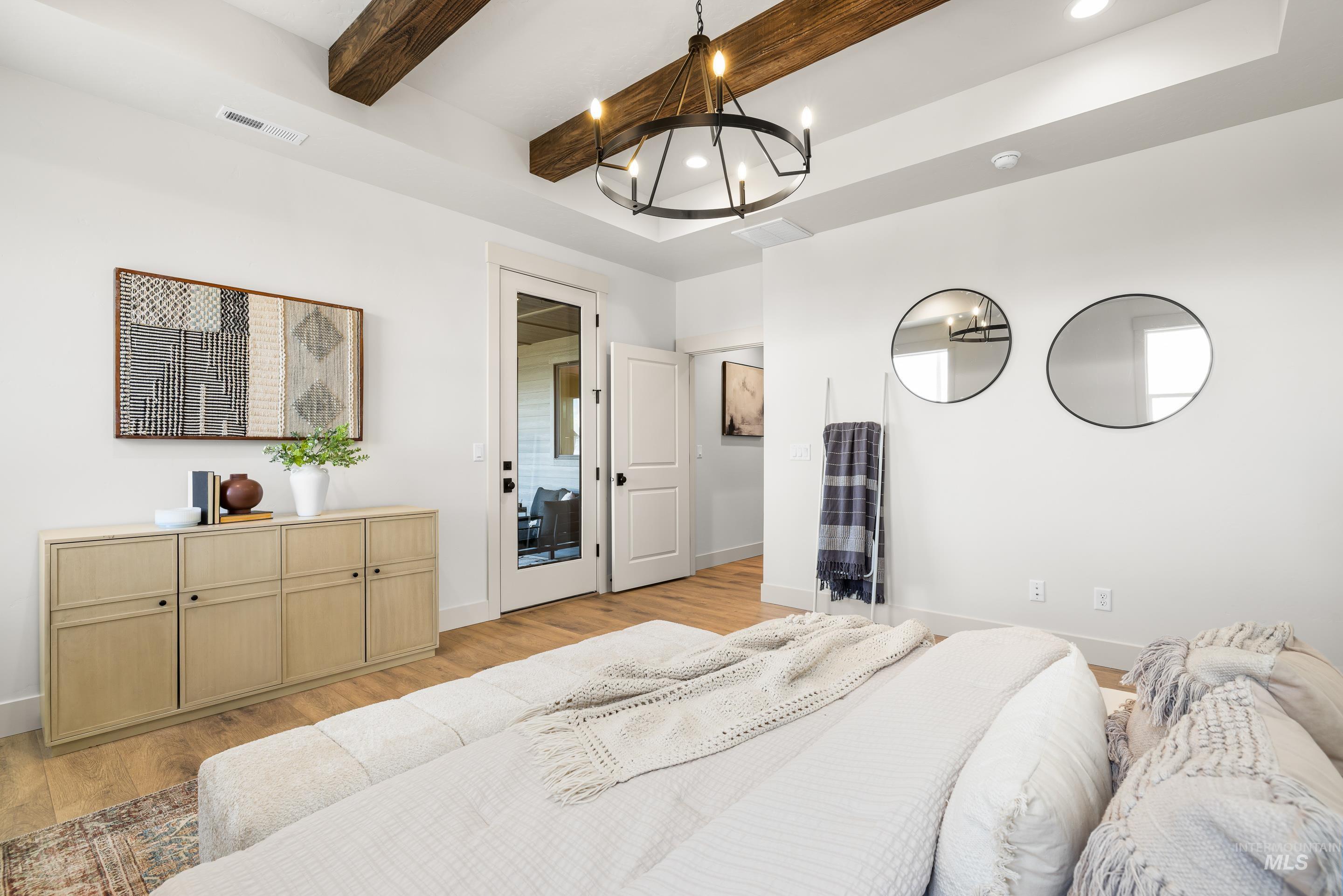 Bedroom featuring light wood-style floors, a chandelier, beamed ceiling, and recessed lighting