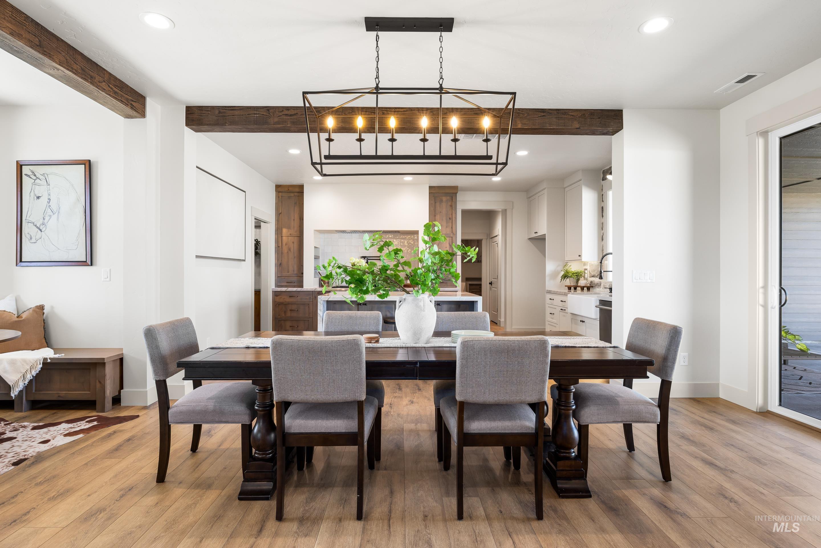 Dining room with recessed lighting, light wood finished floors, and beam ceiling