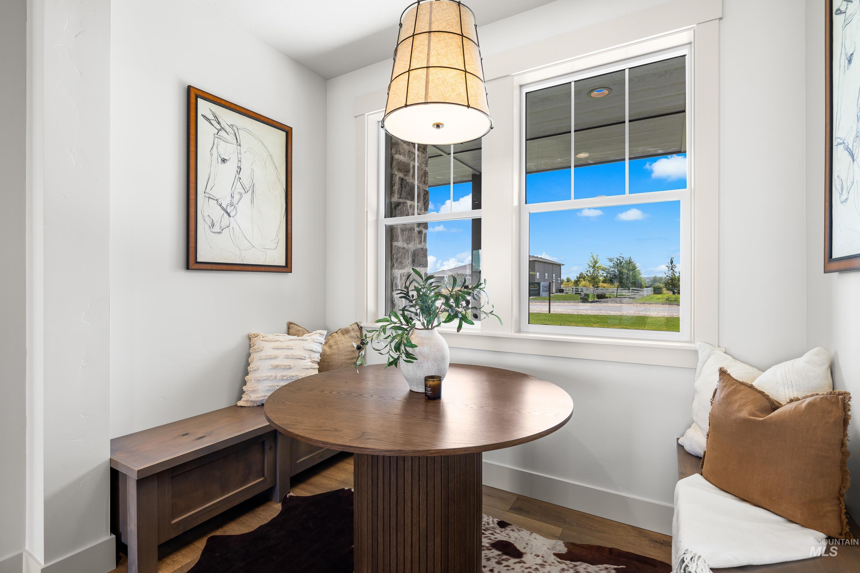 Dining space with wood finished floors and baseboards