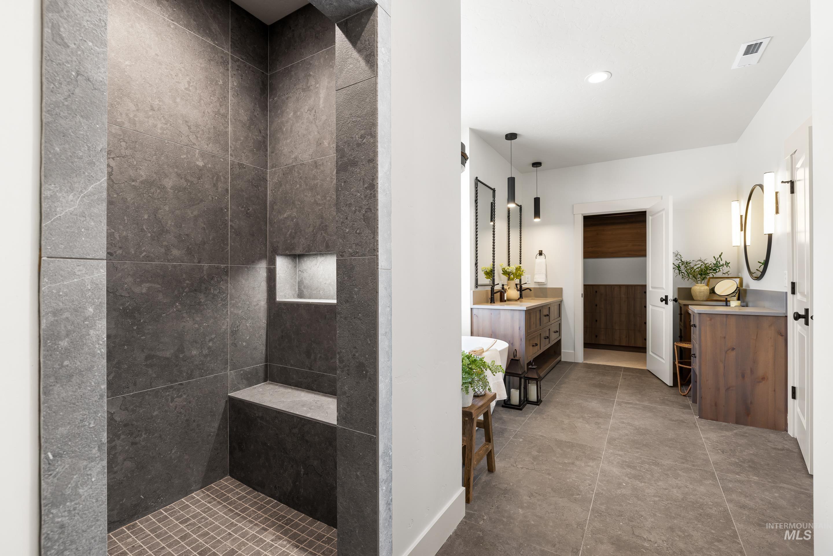 Full bath featuring two vanities, walk in shower, recessed lighting, and tile patterned flooring