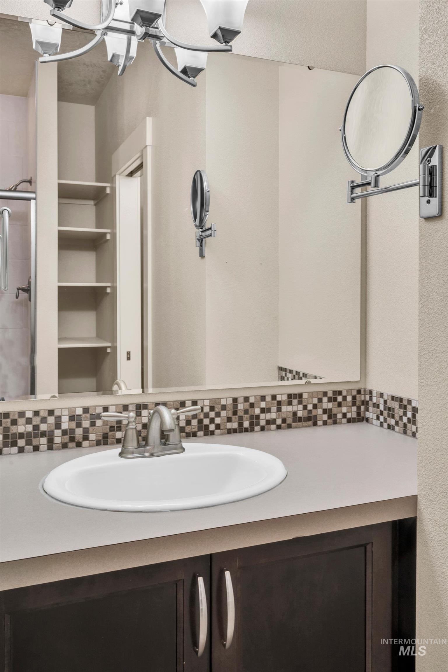 Bathroom with vanity and decorative backsplash