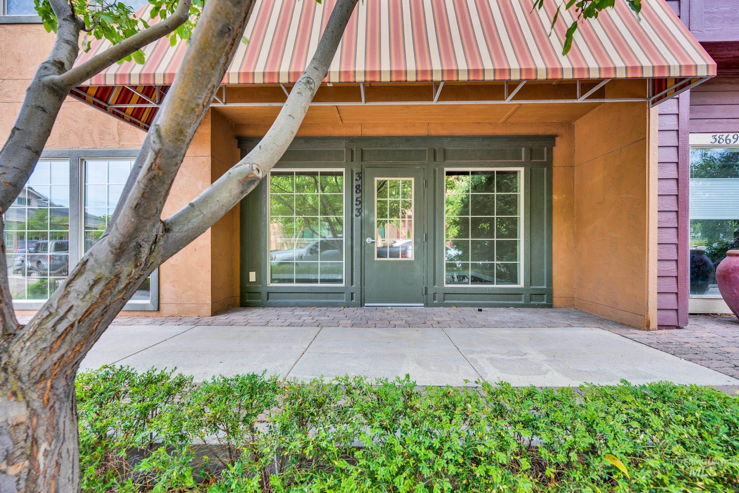Doorway to property featuring a patio and a metal roof