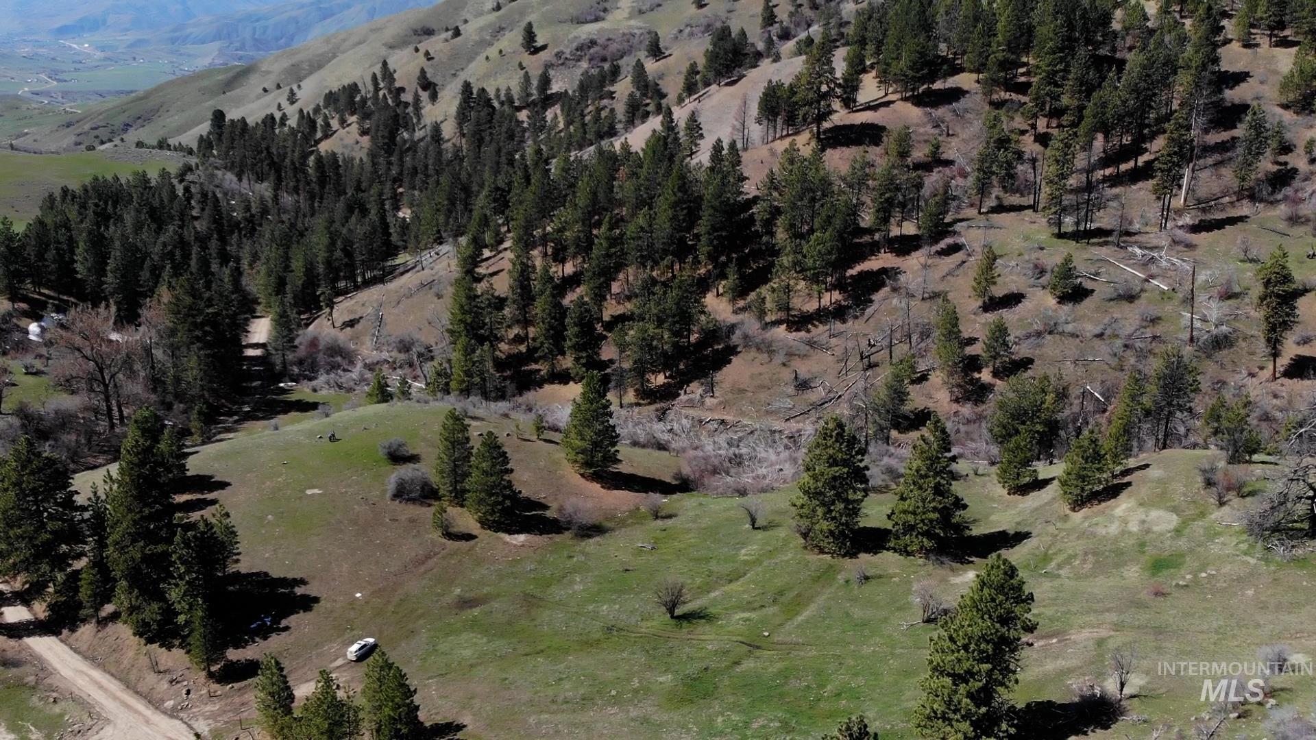 Aerial view of property's location with a mountain backdrop