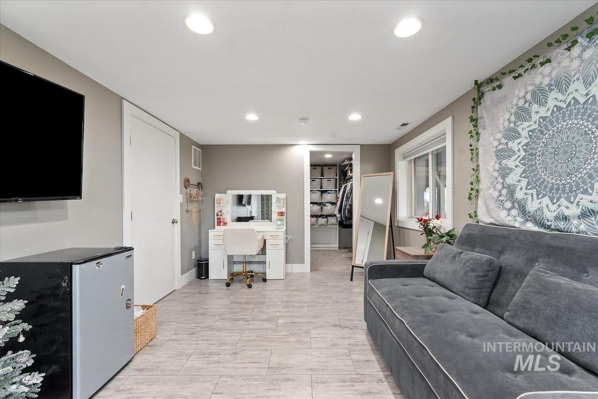 Living room featuring an office area and recessed lighting
