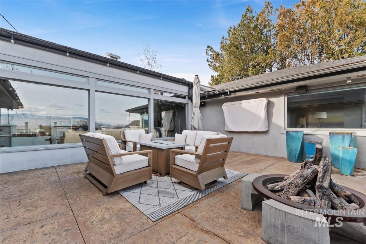View of patio featuring an outdoor living space with a fire pit