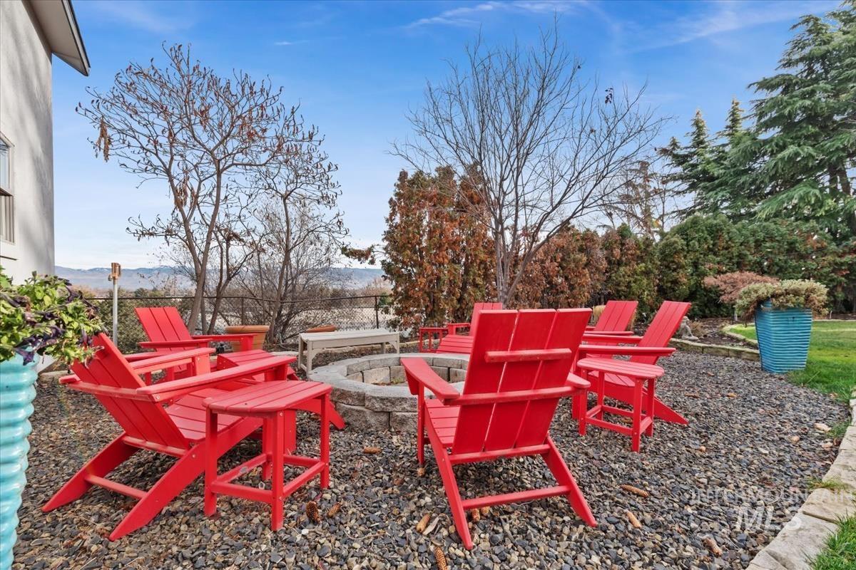 View of patio featuring an outdoor fire pit and a mountain view