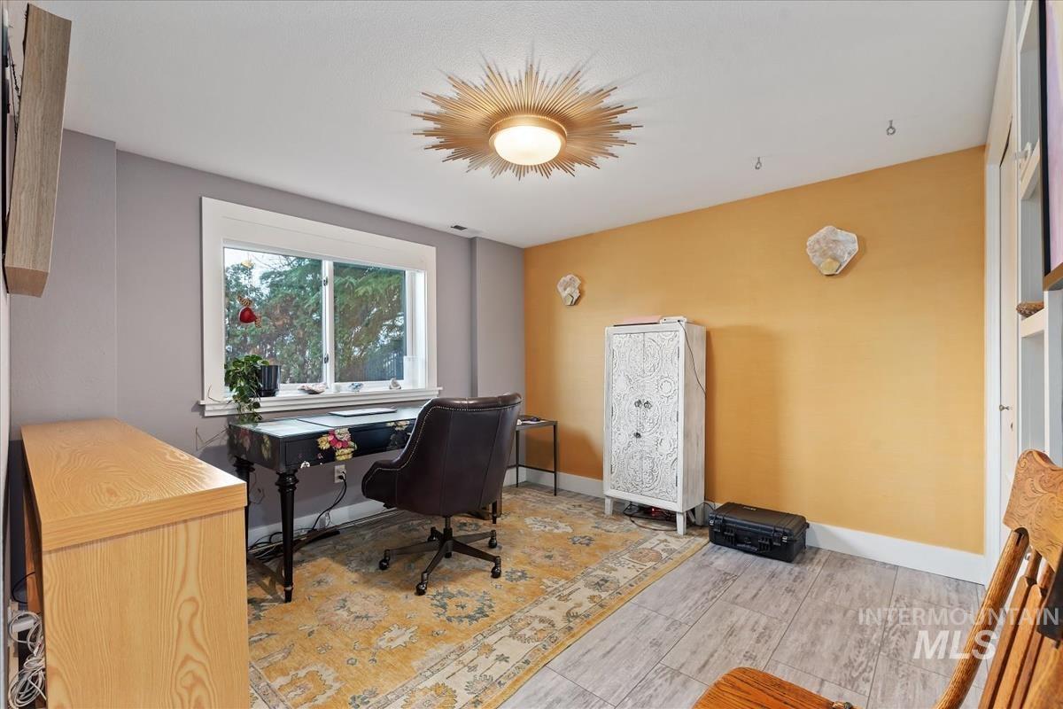Office with baseboards and light wood finished floors