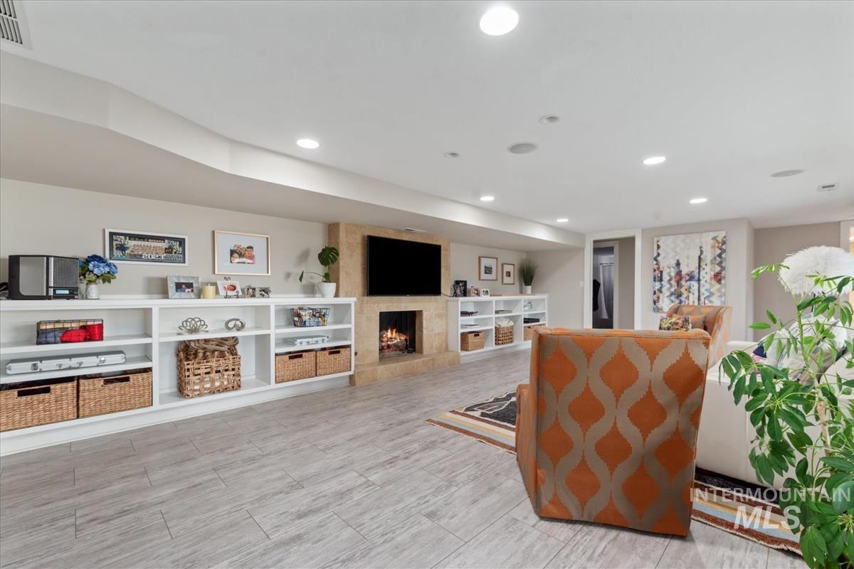 Sitting room featuring a large fireplace and recessed lighting