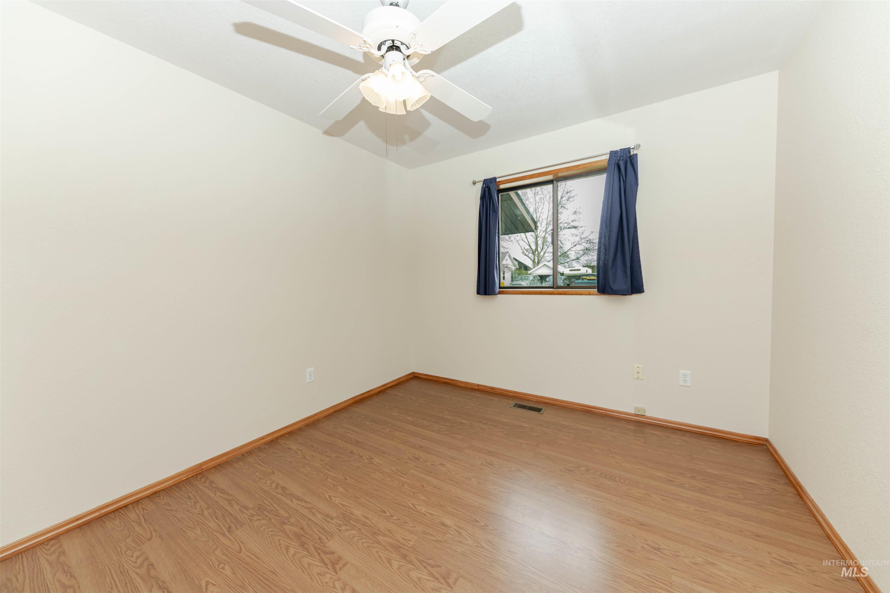 Bedroom with light wood-type flooring and ceiling fan