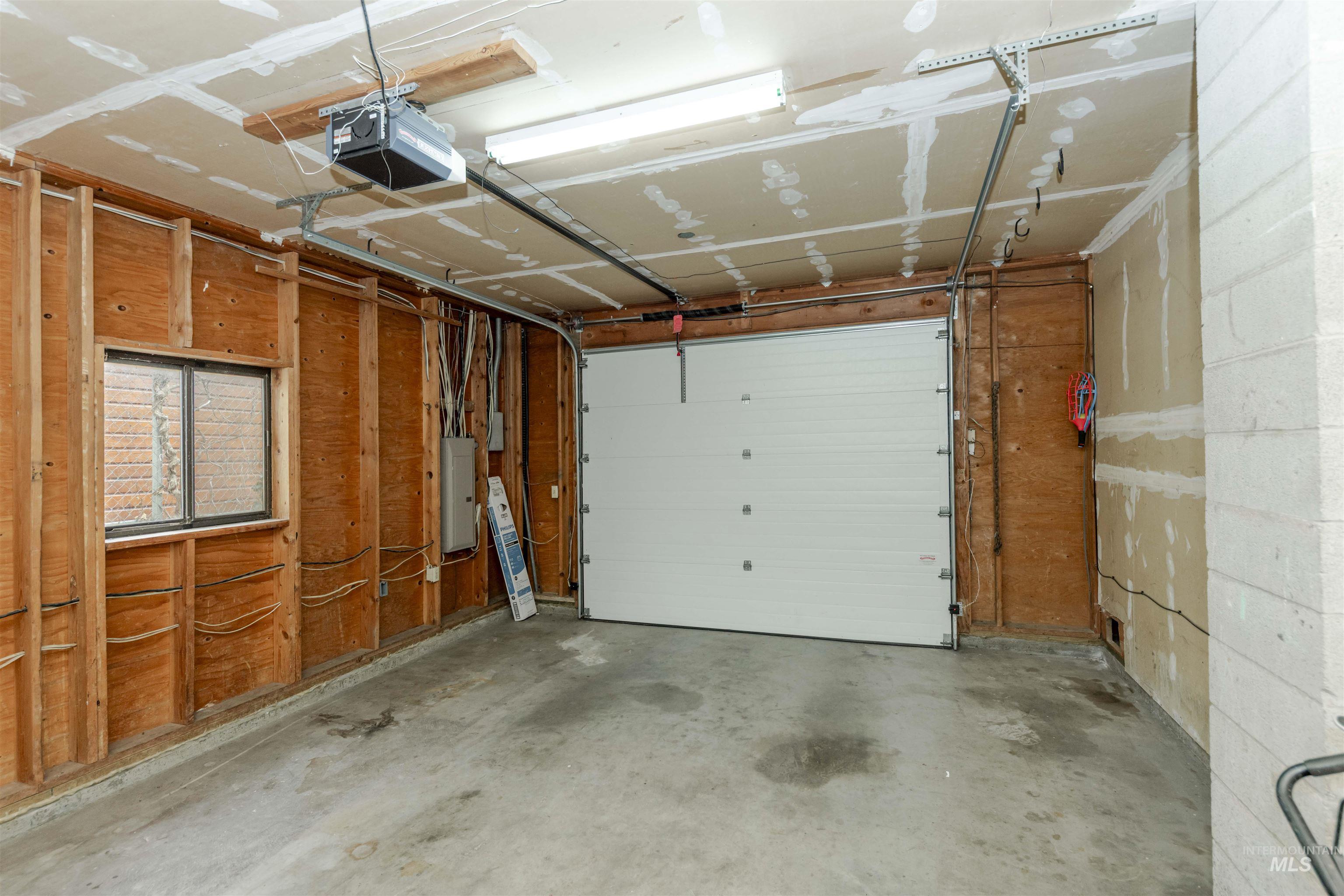 Garage with a garage door opener and electric panel