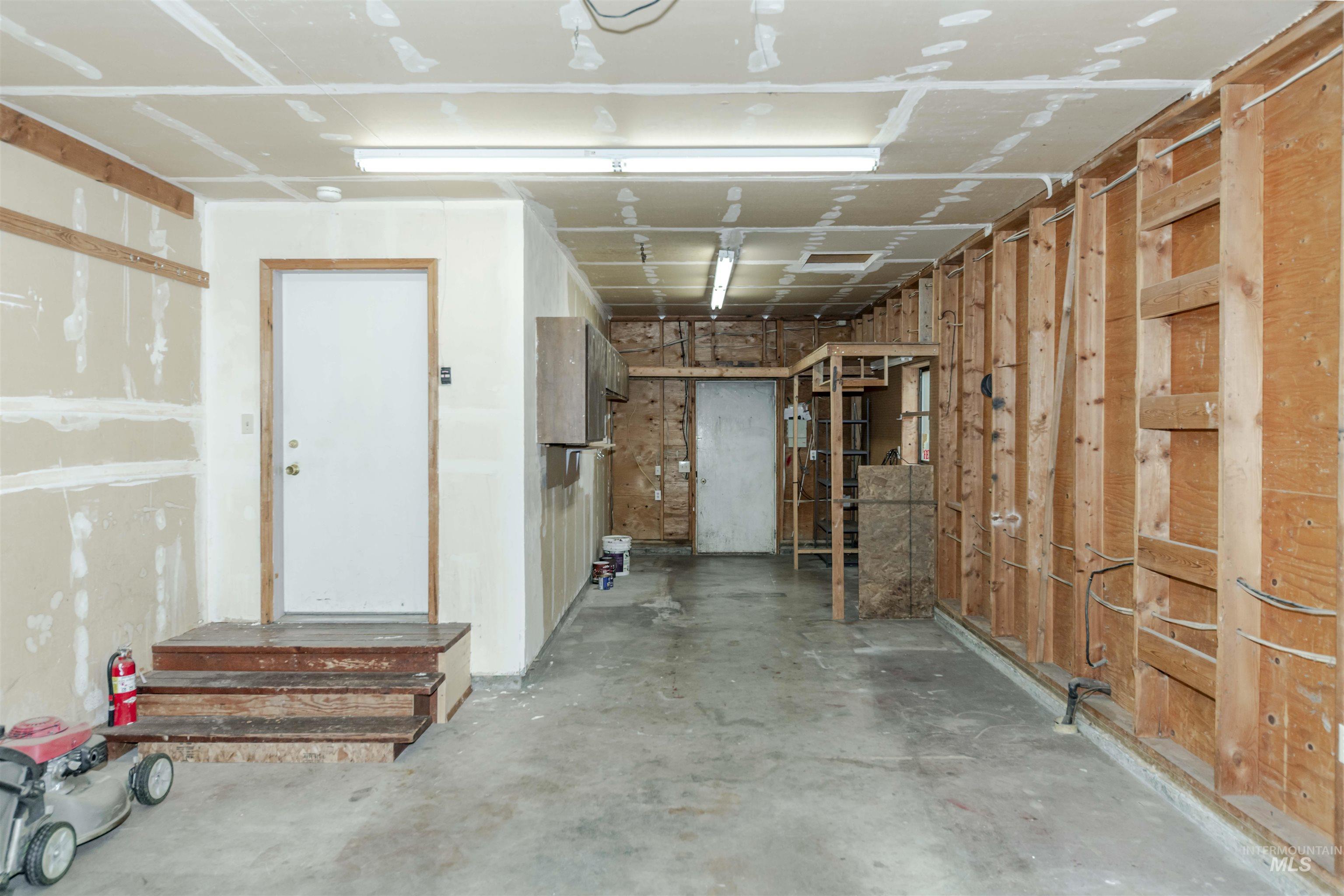 Attached garage with additional storage area.